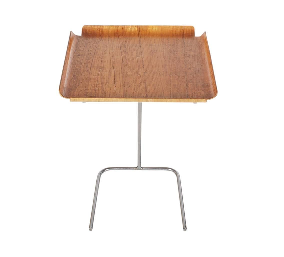 A very nice early example of this table with an uncommon non-adjustable height base. George Nelson for Herman Miller design. It features a molded plywood top in ash and zinc plated steel base.