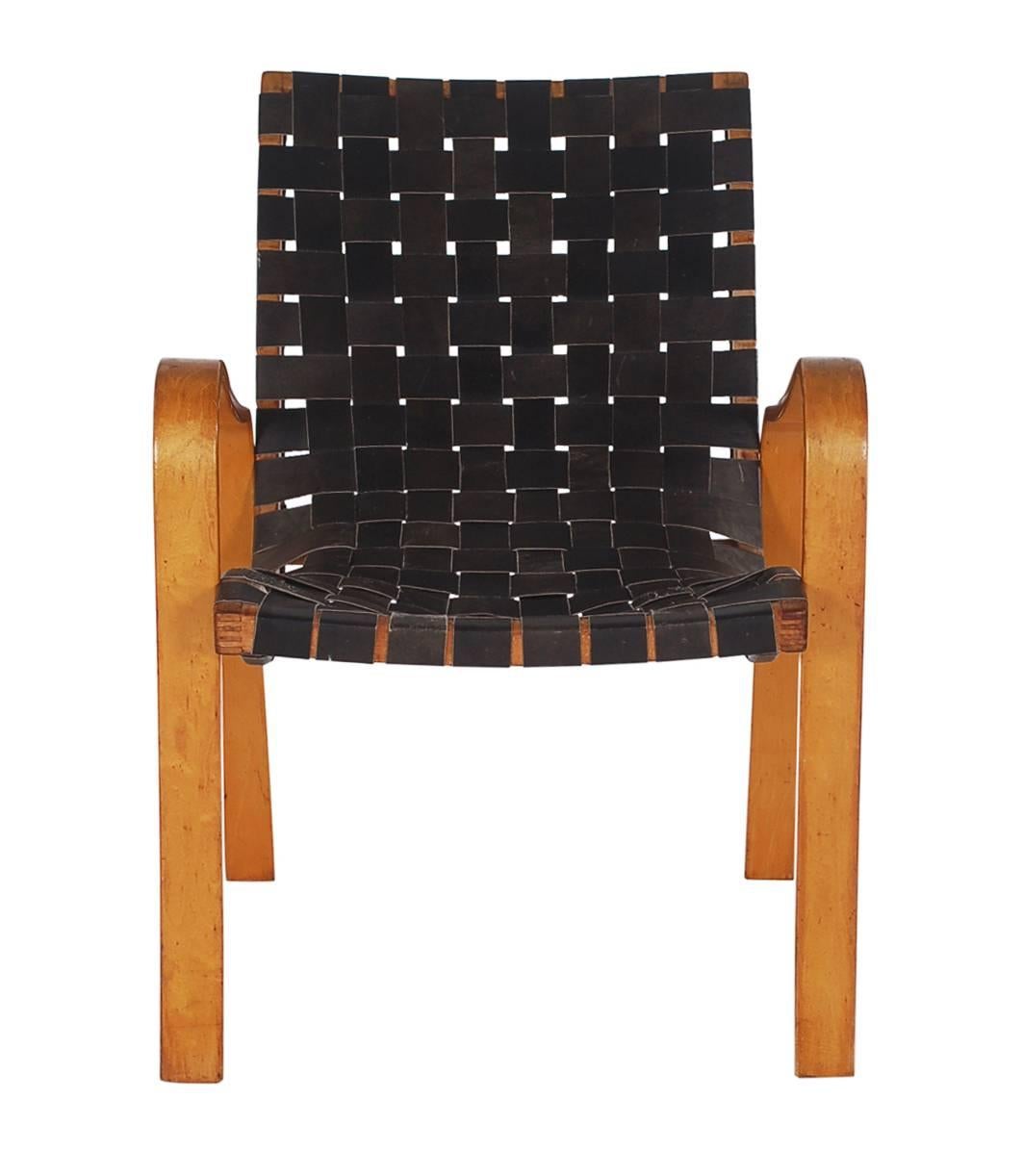 A handsome sitting chair attributed to Bruno Mathsson or Michael Thonet. It features a bent plywood birch frame with black leather straps. All original with exceptional patina.