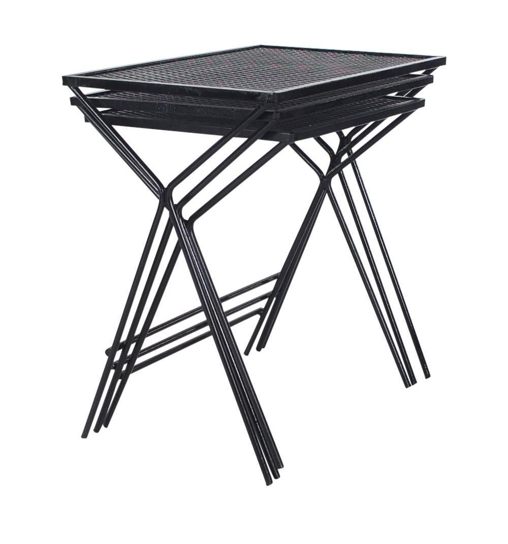 A vintage set of jet black nesting tables designed by John Salterini for Tempestini. They feature wrought iron framing with new black lacquer finish.