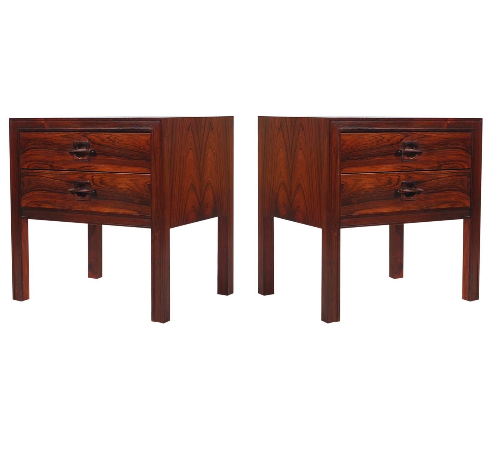 A beautiful matching pair of Danish modern night stands. They feature striking rosewood veneers and heavy solid construction.