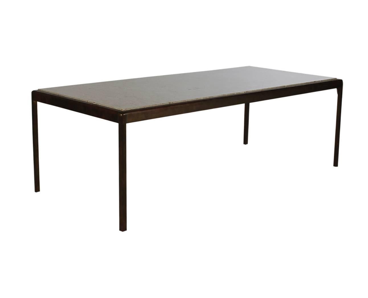 An incredibly heavy and well made coffee table in the manner of Florence Knoll. It features a solid bronze heavy frame with an inlaid Perlato marble.