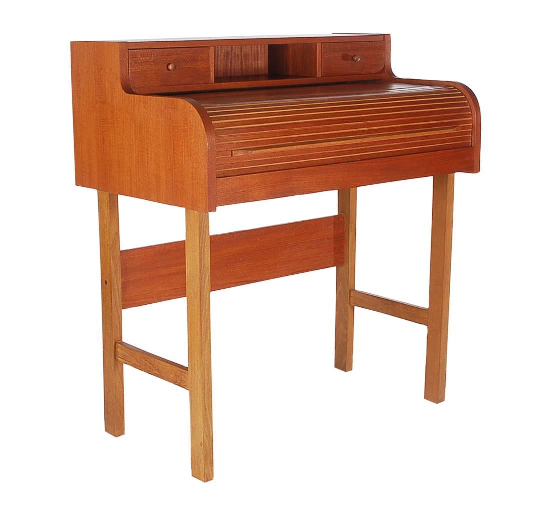 A uniquely proportioned roll to desk. It features teak construction, laminate writing area with plenty of storage.