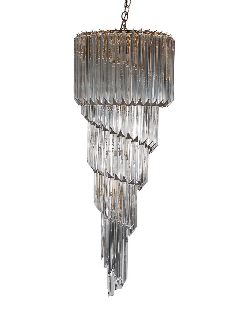 A large and impressive Italian spiral chandelier produced by Camer in the 1970s. It features gold-plated brass framing with crystal glass prisms in a spiral form. Tested and working. Marked: Made in Italy.