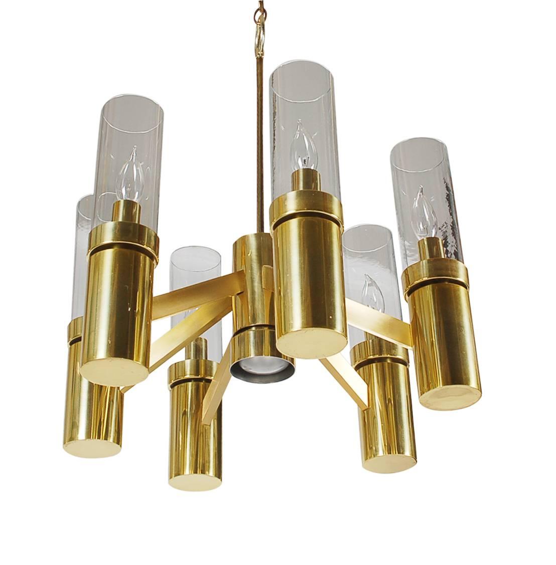 A beautiful modern design by Gaetano Sciolari for Lightolier Lighting Company. It features a brass plated frame with six hurricane glass tube shades.