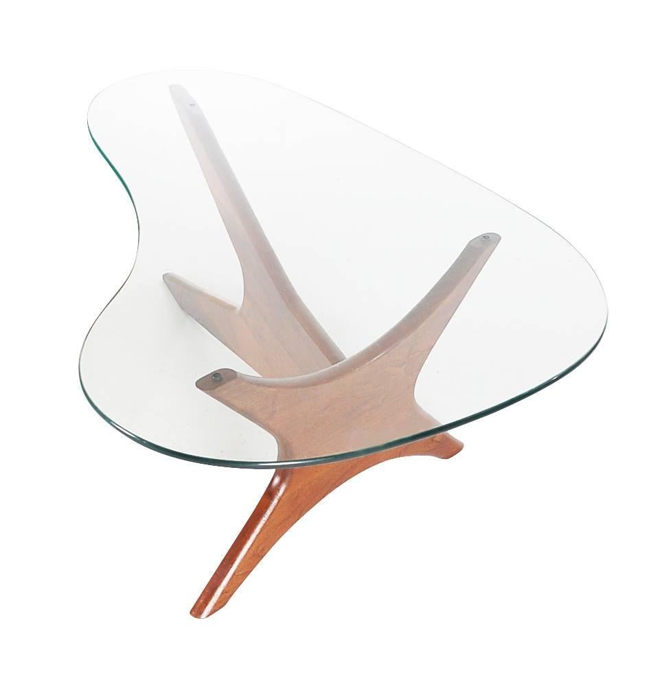 A stylish modern design created by Adrian Pearsall for Craft Associates. It features a sculptural solid walnut base, with thick free-form glass top.