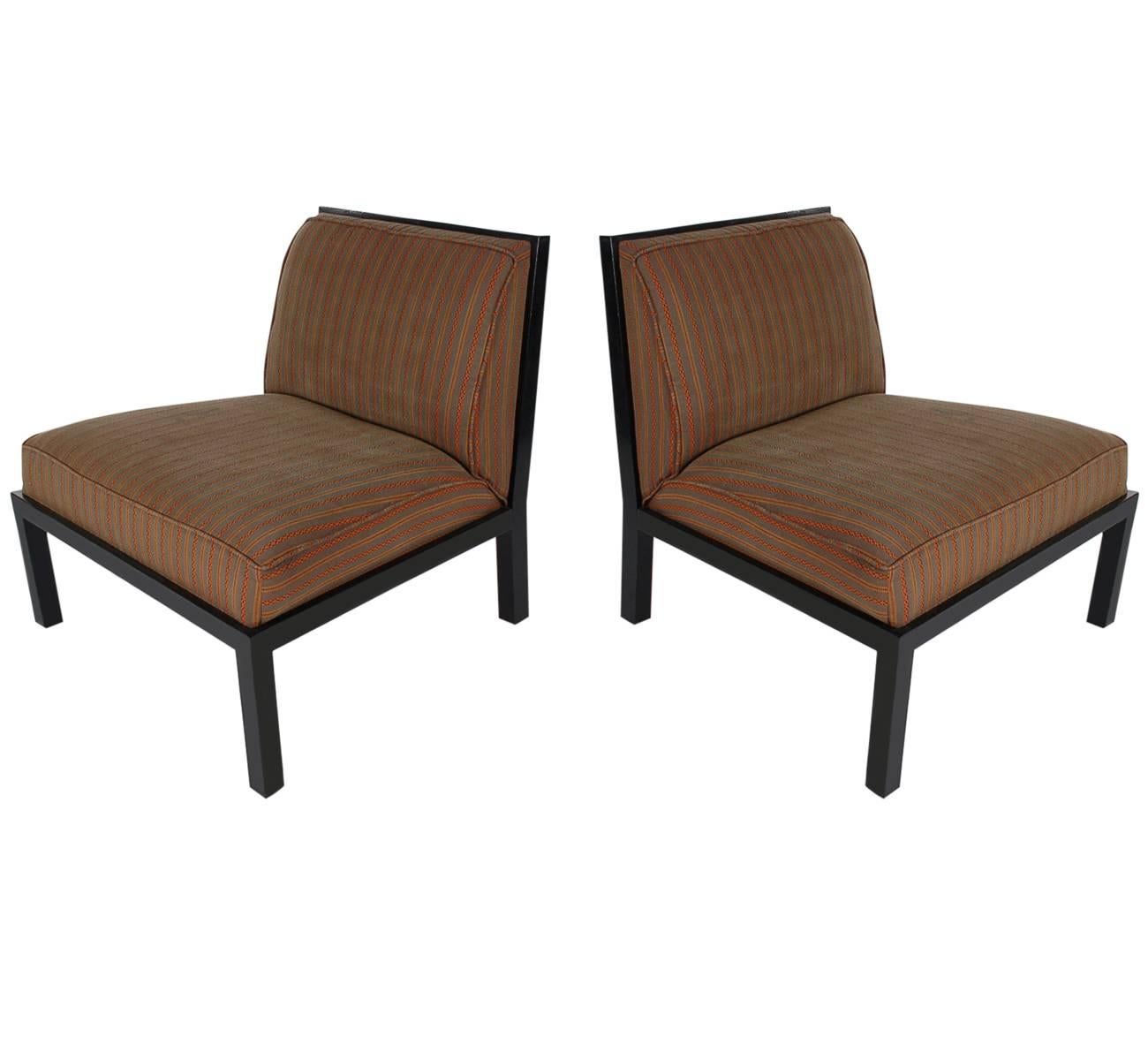 A handsome matching pair of slipper lounge chairs designed by Michael Taylor and produced by Baker Furniture. These feature ebony wood frames with beautiful lattice backs. Fabric is worn and needs recovering. Upholstery services are available at