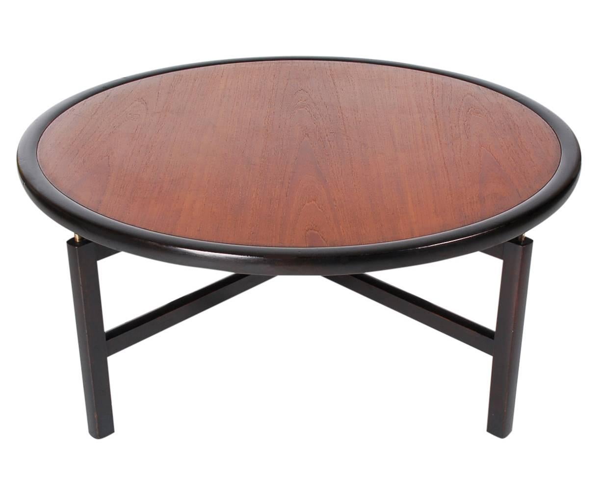 A chic an elegant Classic designed by Michael Taylor for Baker Furniture. It features an ebony finish along with a beautifully grained teak top. Metal Baker tag on underside. Will work great with Danish modern or many other aesthetics.