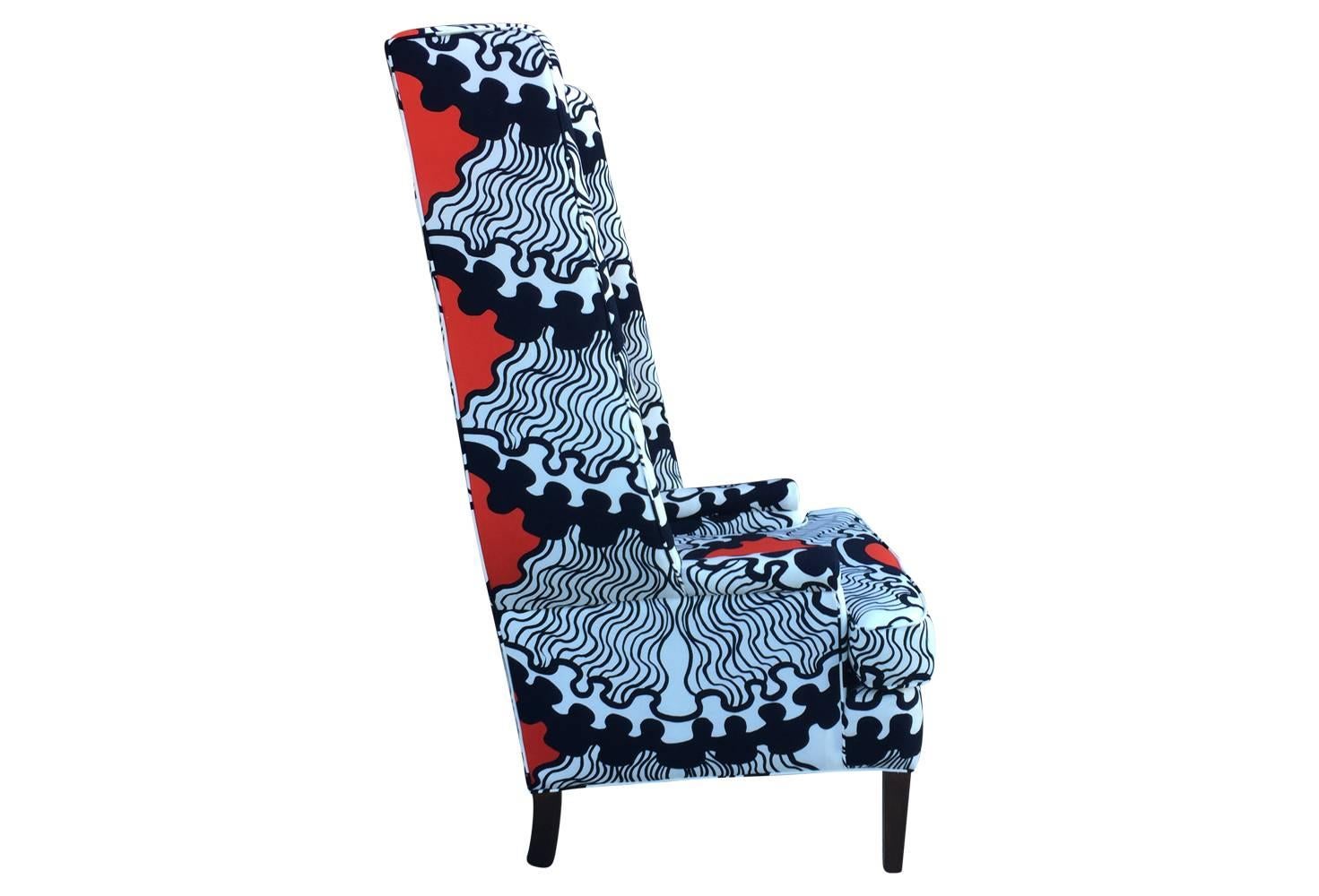 This oversized wingback chair has been completely restored and upholstered in a vintage Mid-Century Modern abstract fabric, with red, white and blue designs. Fabric is reminiscent of the designs of Marimekko. Seat height 19 and depth 17.