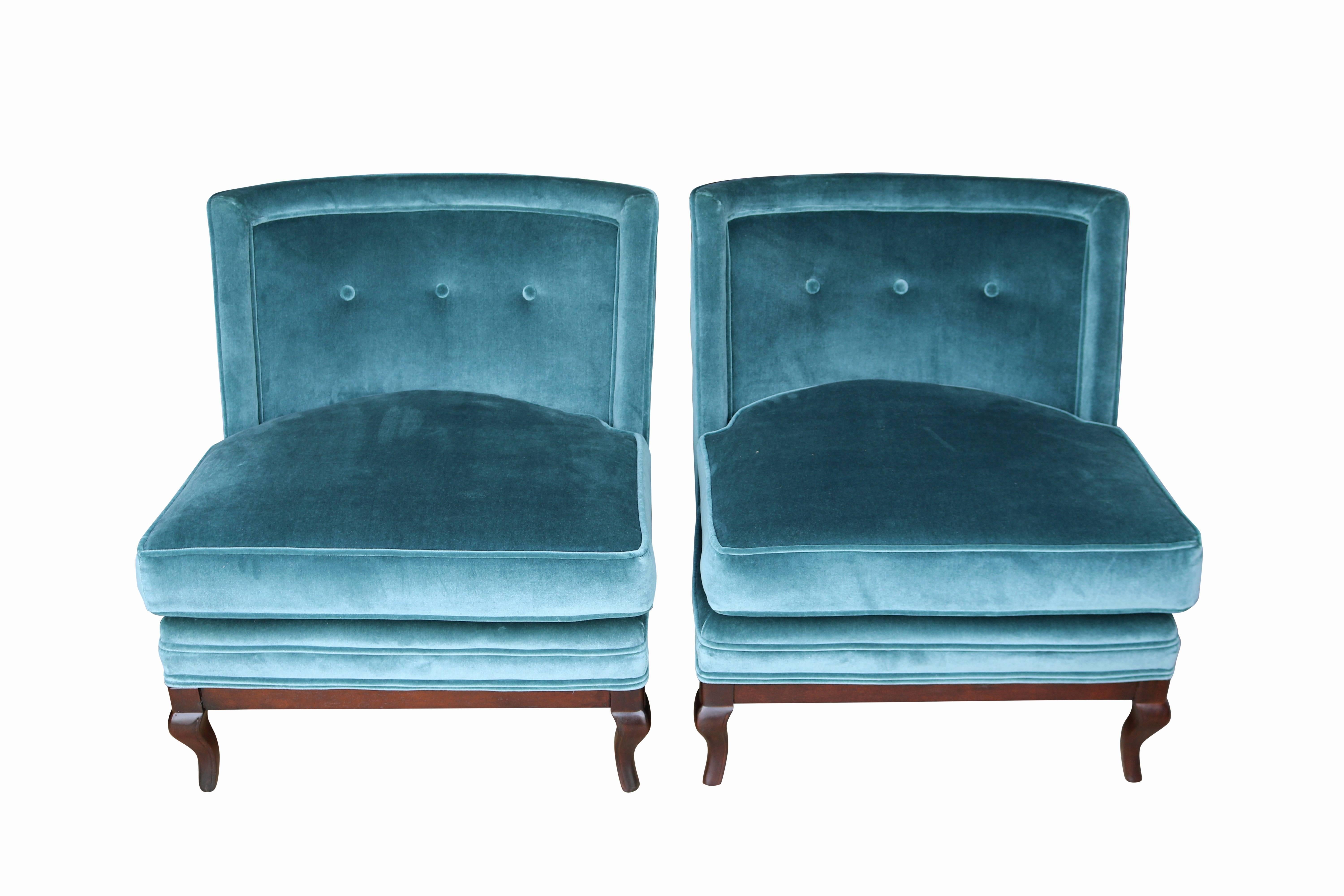 This sophisticated pair of slipper chairs has been lovingly restored. Upholstered in a lush blue velvet with mohair appeal, these chairs are comfortable and luxurious to the touch. Curved walnut legs nod to a more traditional style, making these