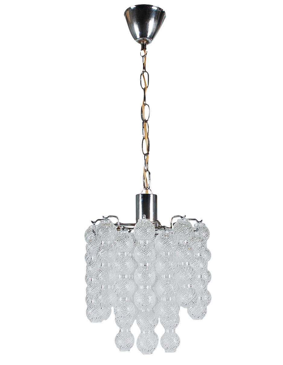 A luxurious and chic looking Italian chandelier, circa 1960s. It features hanging sculpted glass tubes from a solid chrome-plated frame. Tested, working and ready for immediate use.