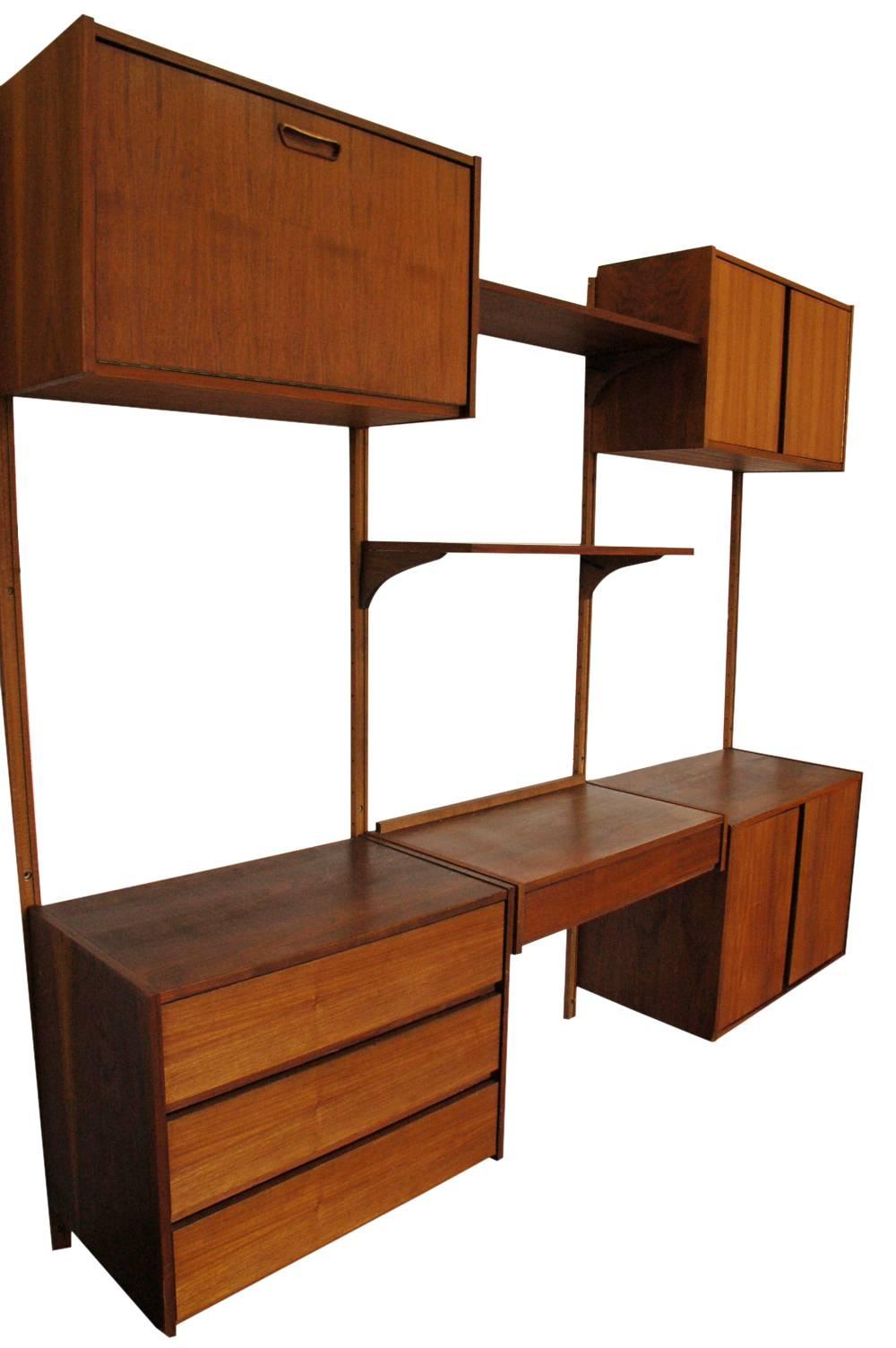 A large three-bay teak wall unit in the style of Poul 