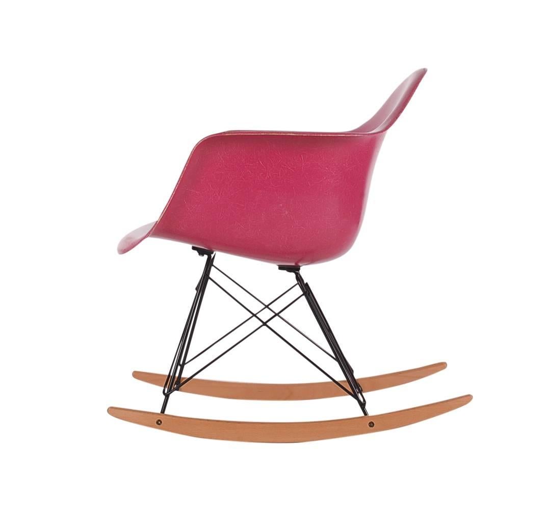 Hot pink is known to be one of the rarest color to collectors worldwide. Here we have a vintage arm shell produced by Herman Miller in the early 1970s. Rocker base is a newer production, chair seat is vintage. Embossed logo.
