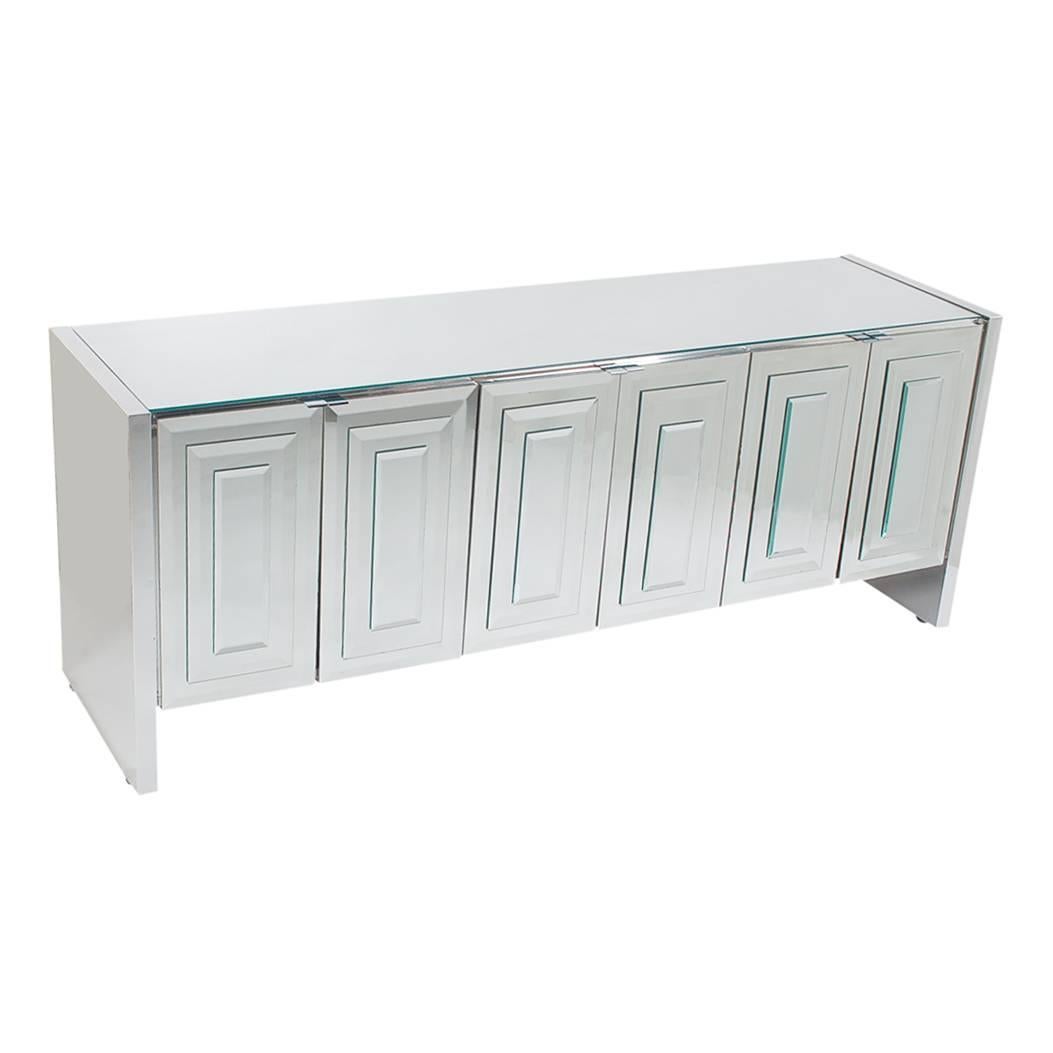 A chic and glamorous mirrored six-door cabinet made by Ello. It features Art Deco mirror stacked doors with chrome trim. Interior is off-white laminate. 

In the style of: Pierre Cardin, Mastercraft, Paul Evans.
