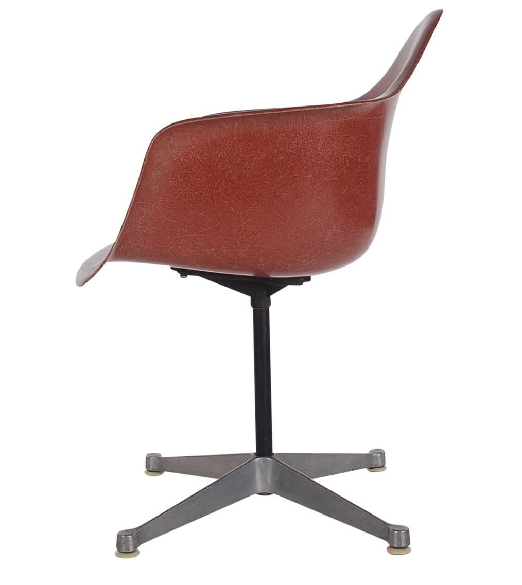 Here we have an iconic design Classic from the Mid-Century Modern period. This vintage fiberglass shell chair was designed by Charles Eames and produced by Herman Miller, circa 1972. All are very uncommon colors, chocolate, terracotta, navy, and