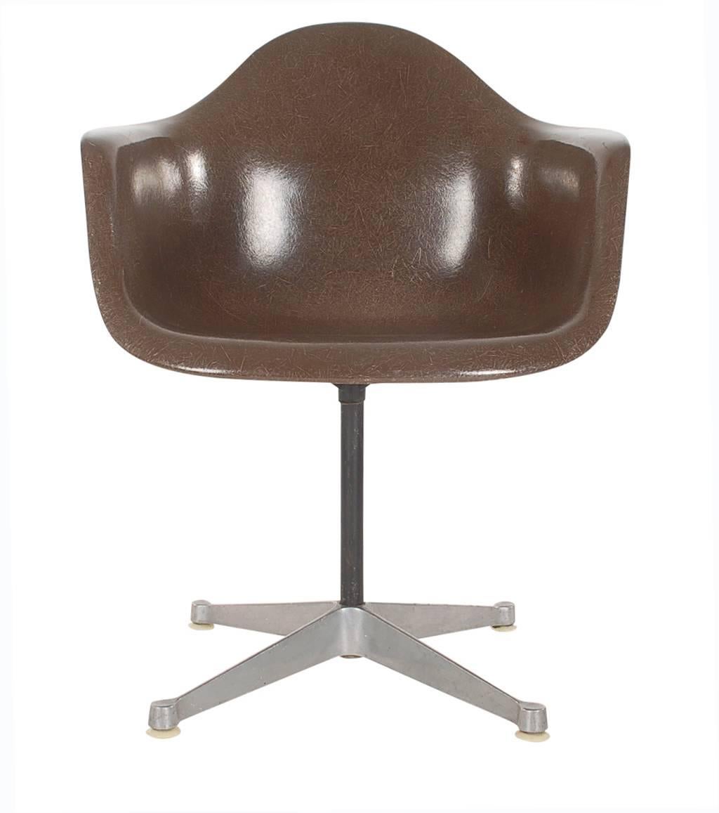 Here we have an iconic design Classic from the Mid-Century Modern period. This vintage fiberglass shell chair was designed by Charles Eames and produced by Herman Miller, circa 1972. Very uncommon chocolate brown color. These chairs are sold with