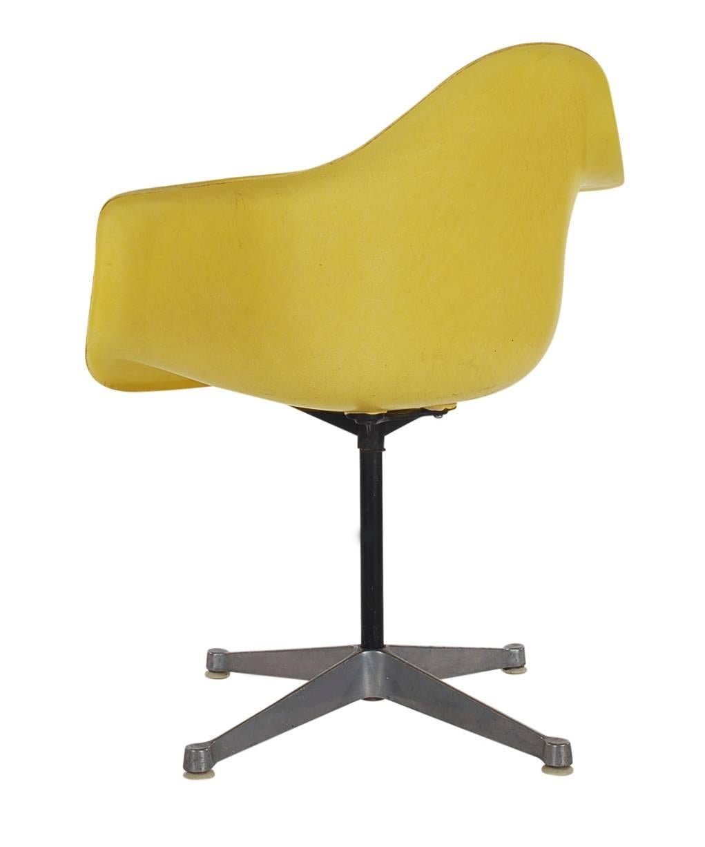 Here we have an iconic design Classic from the Mid-Century Modern period. This vintage fiberglass shell chair was designed by Charles Eames and produced by Herman Miller, circa 1972. A great mix of colors, blue, yellow, orange and black shells.