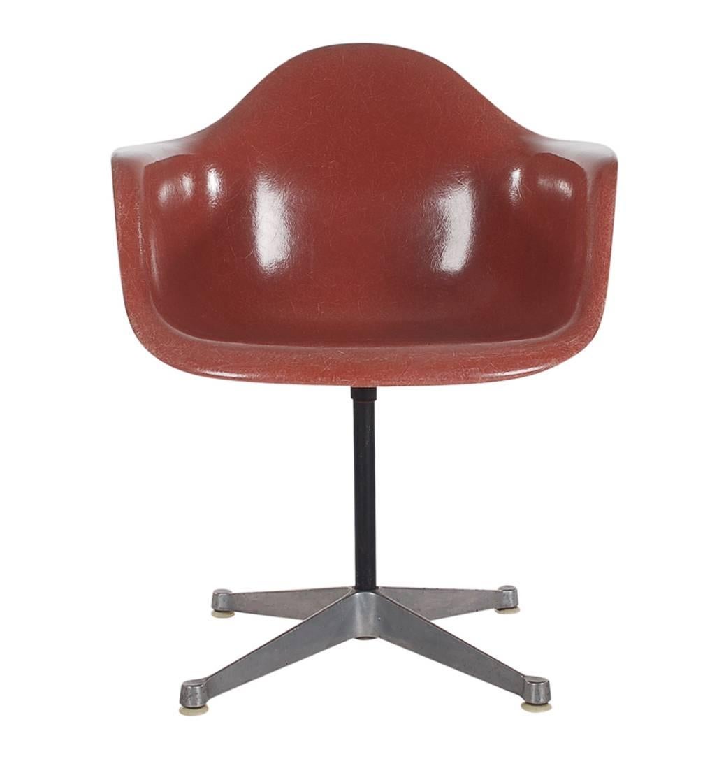 Here we have an iconic design Classic from the Mid-Century Modern period. This vintage fiberglass shell chair was designed by Charles Eames and produced by Herman Miller, circa 1972. Very hard to find terracotta color. These chairs are sold with