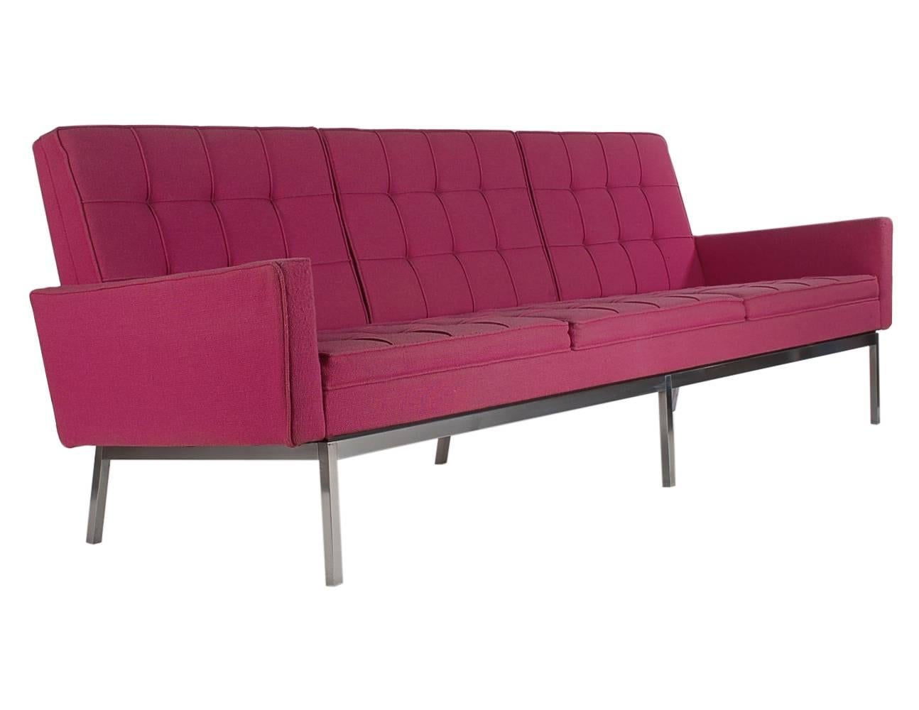 An iconic sofa designed by Florence Knoll and produced by Knoll in the early 1960s. It features a stainless steel frame with fuchsia tweed upholstery.