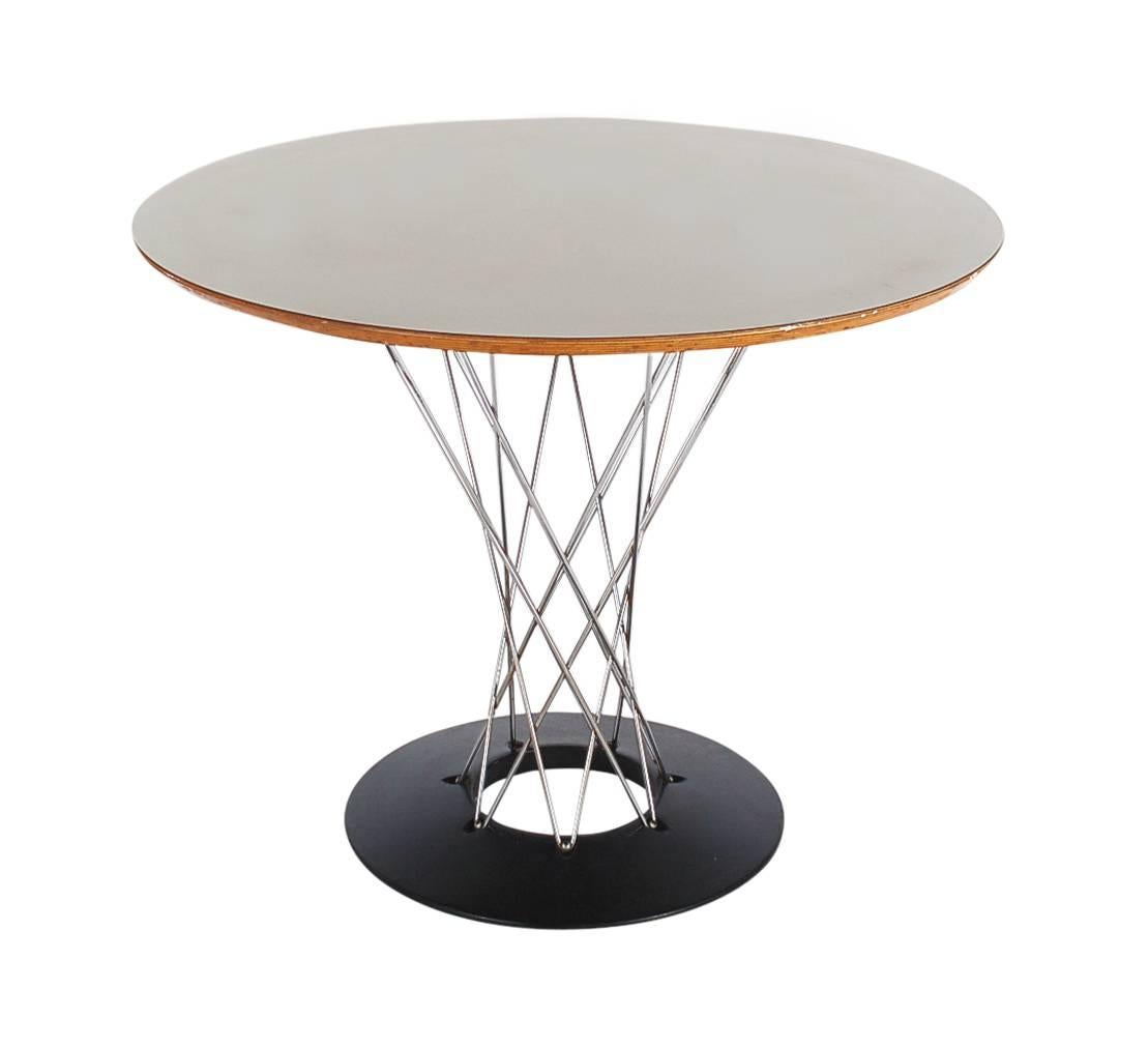 An early 1950s example of Isamu Noguchi's cyclone dining table produced by Knoll. It features a 36 inch laminate top, steel wire supports and an iron base.