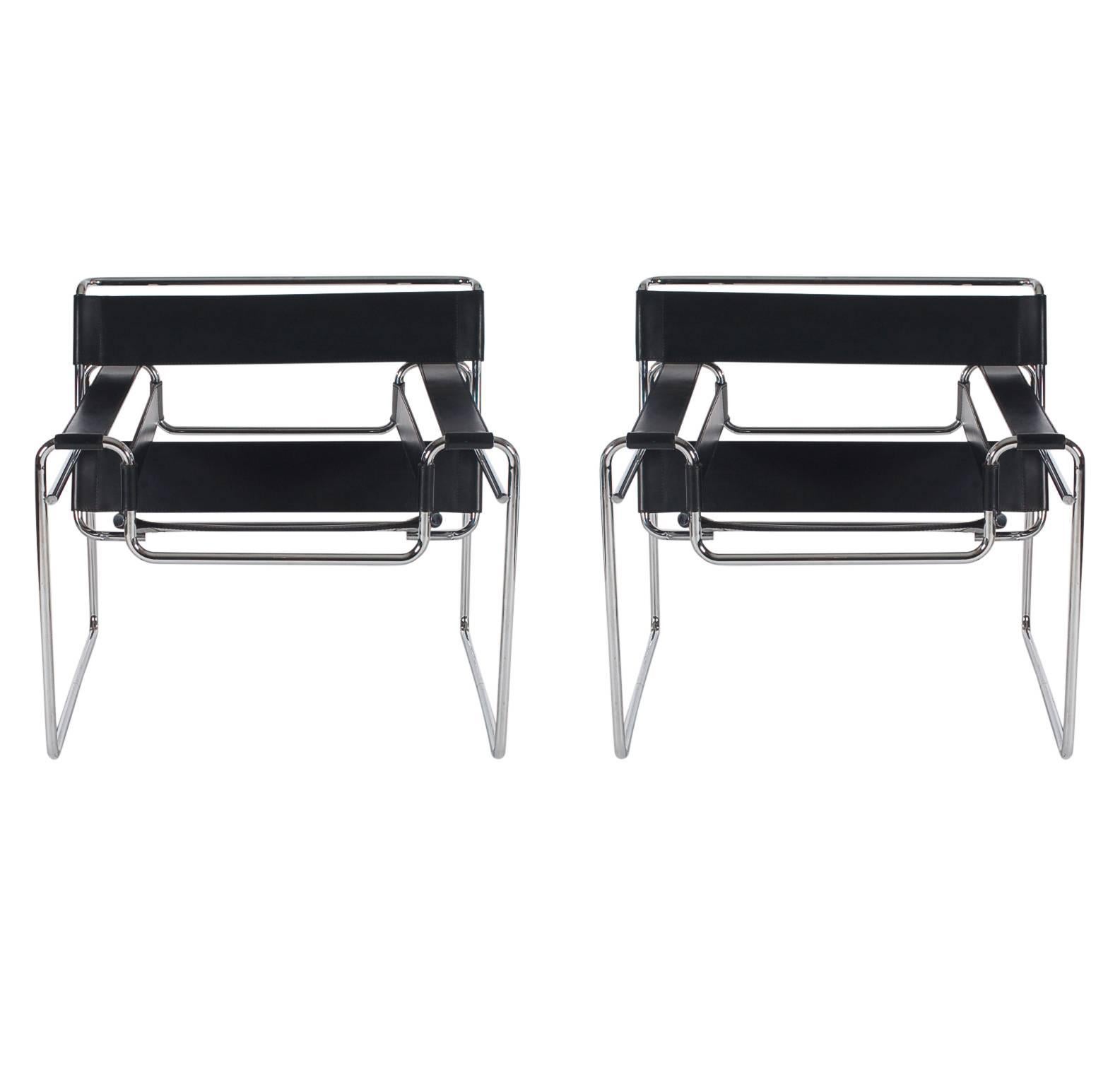 Authentic pair of Wassily chairs designed by Marcel Breuer and produced in Italy for Knoll. Well made sturdy chrome chair frames with thick black leather. These are licensed chairs signed by Knoll.