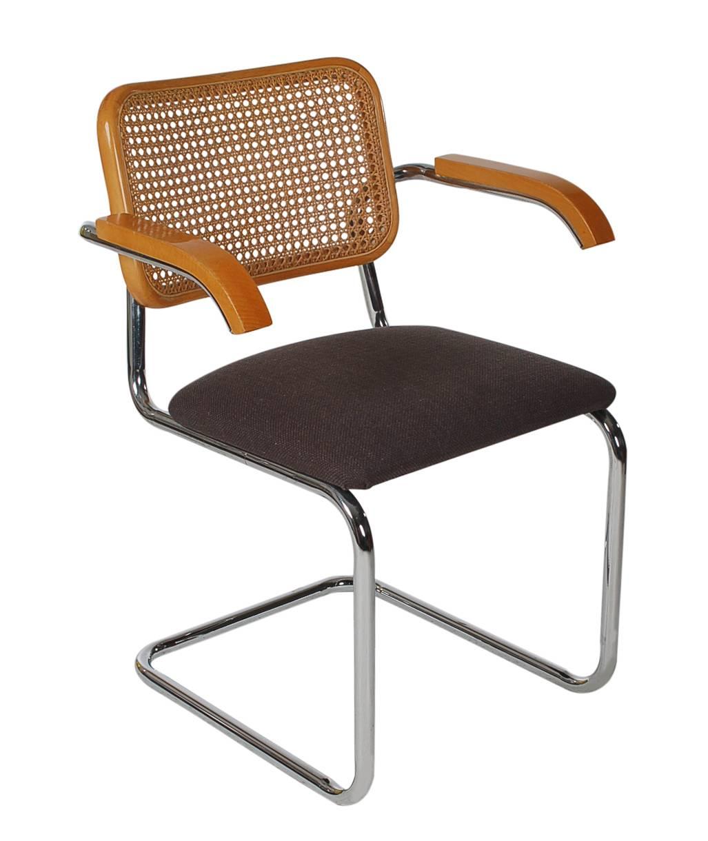 A super clean vintage set of four Cesca dining chairs designed by Marcel Breuer and produced by Knoll, circa 1980s. They feature chrome-plated tubular frames, maple wood details, cane backs and recently upholstered charcoal tweed seat cushions.