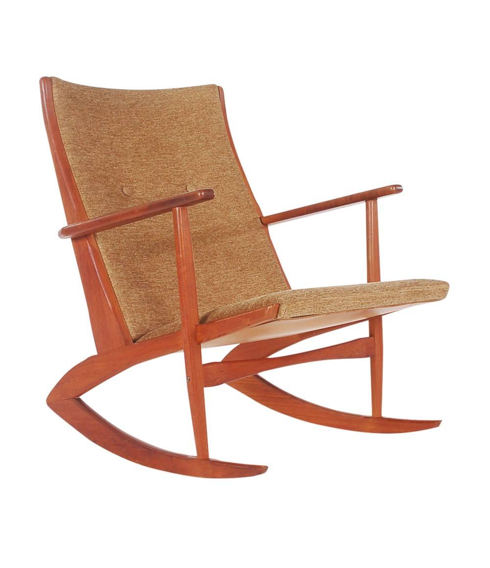 A Classic designed rocking chair by one of the greats, Soren Georg Jensen. It features solid teak framing with newly upholstered tweed cushions.