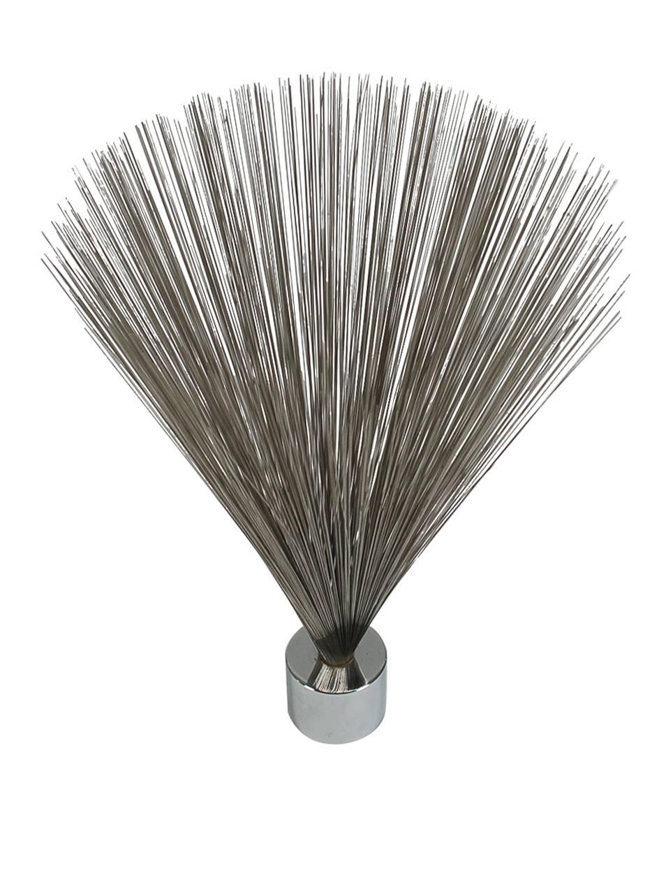 A very cool vintage wire spray sculpture designed and manufactured by Dave Grossman in the 1970s. It features a heavy chrome cylinder base with 100s of thin wires splayed out. 

In the style of: Harry Bertoia or Curtis Jere