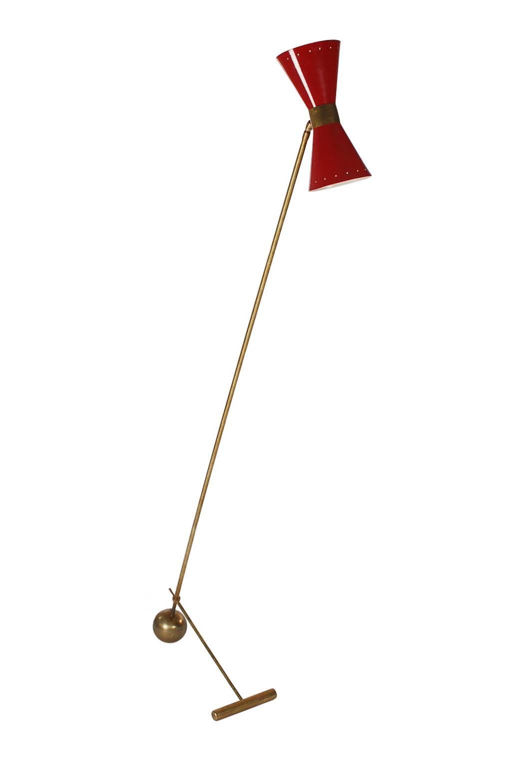 A fine Italian floor lamp from the 1950s. It features solid brass base and stand with a red enameled shade. Probably Stillovo, Arredoluce, or Arteluce. The brass has a beautiful warm patina. Takes two standard bulbs. Tested and fully working.