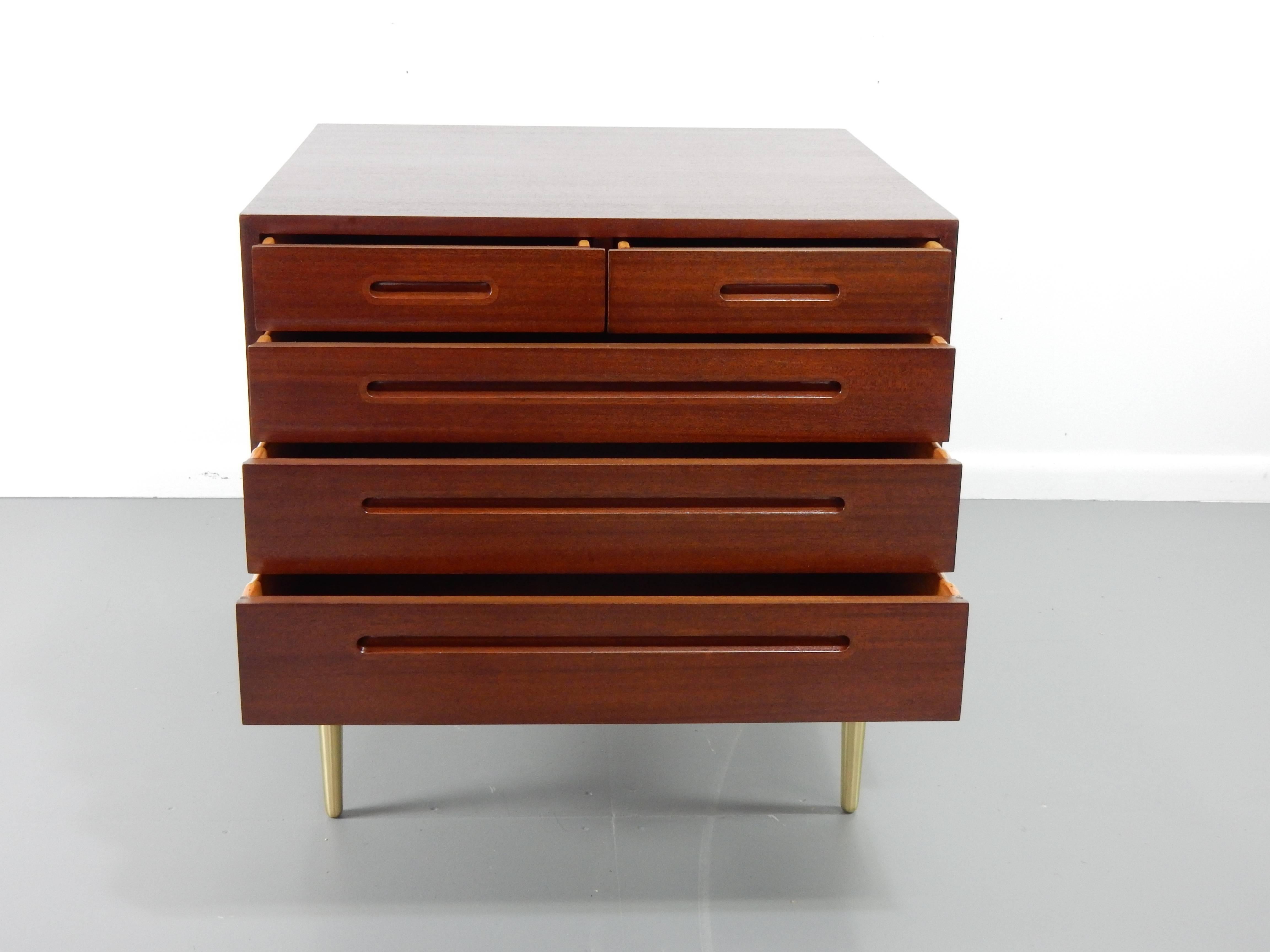 Please find a commode finished in stained mahogany and raised on tapered brass legs by Edward Wormley for Dunbar. American, circa 1950.

Edward Wormley worked in that extraordinary period with Harvey Probber, Vladimir Kagan, George Nelson, Harry
