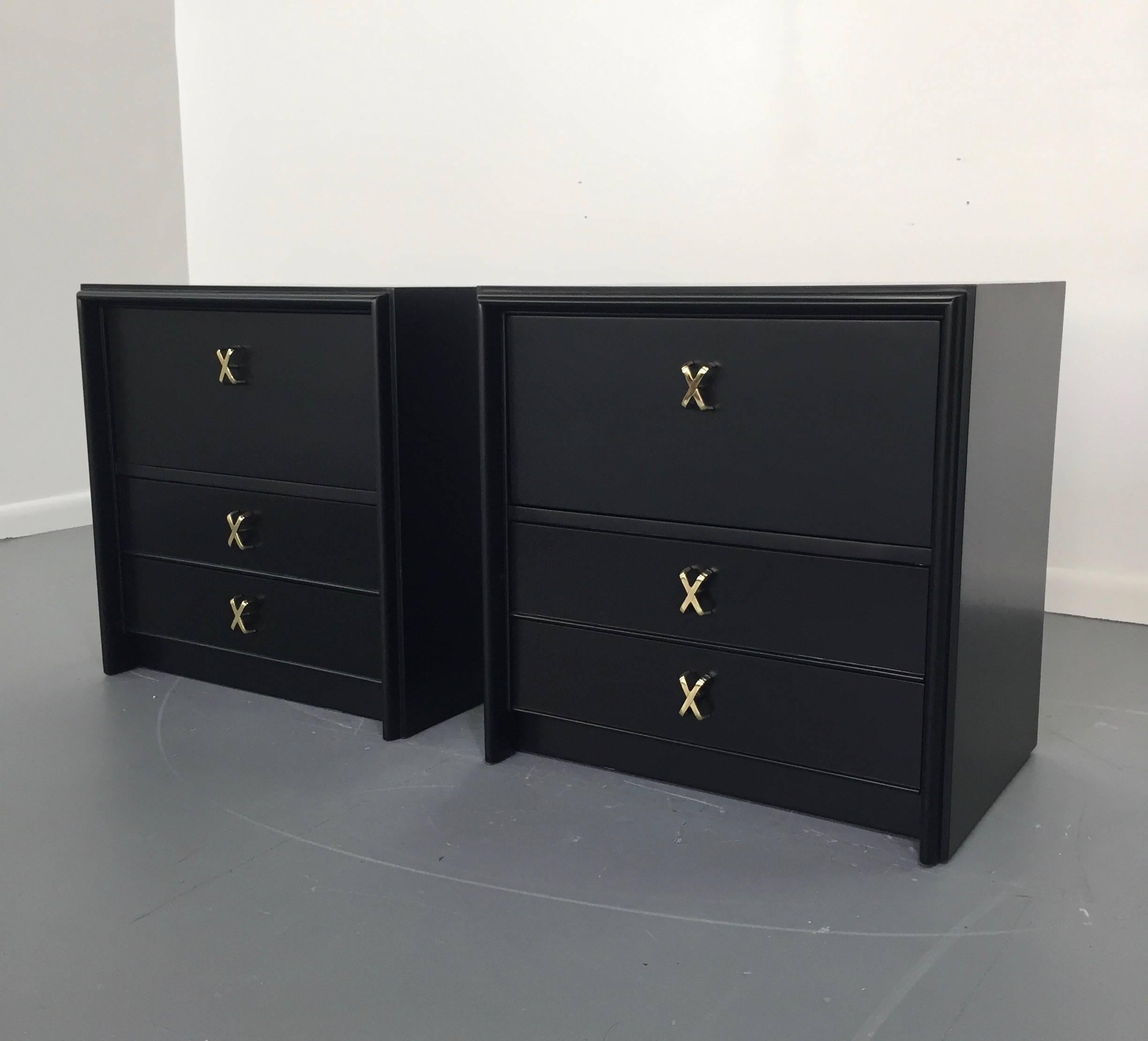 A pair of Paul Frankl designed for Johnson Furniture black lacquered side cabinets with brass-plated metalwork. 1950s stamped with makers mark. Fully reconditioned, top drawer is a fall front hinged shelf.

Paul Frank bridged the period of art deco