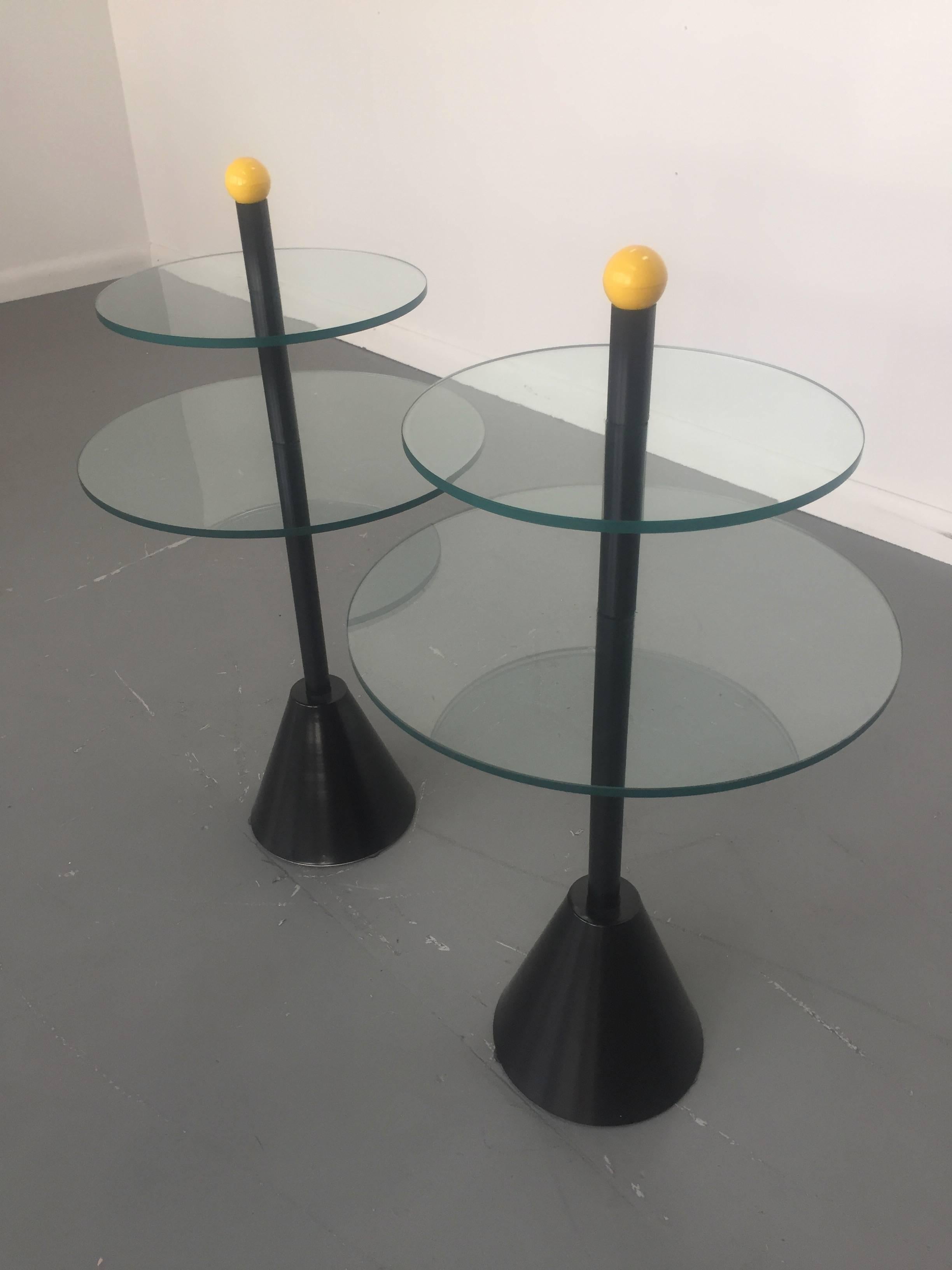 These side tables have received a new coat of black enamel with two tiers of glass and a playful splash of yellow on top. These Memphis tables are in the style of Sottass, de Lucchi, Shire, Zannini. 


