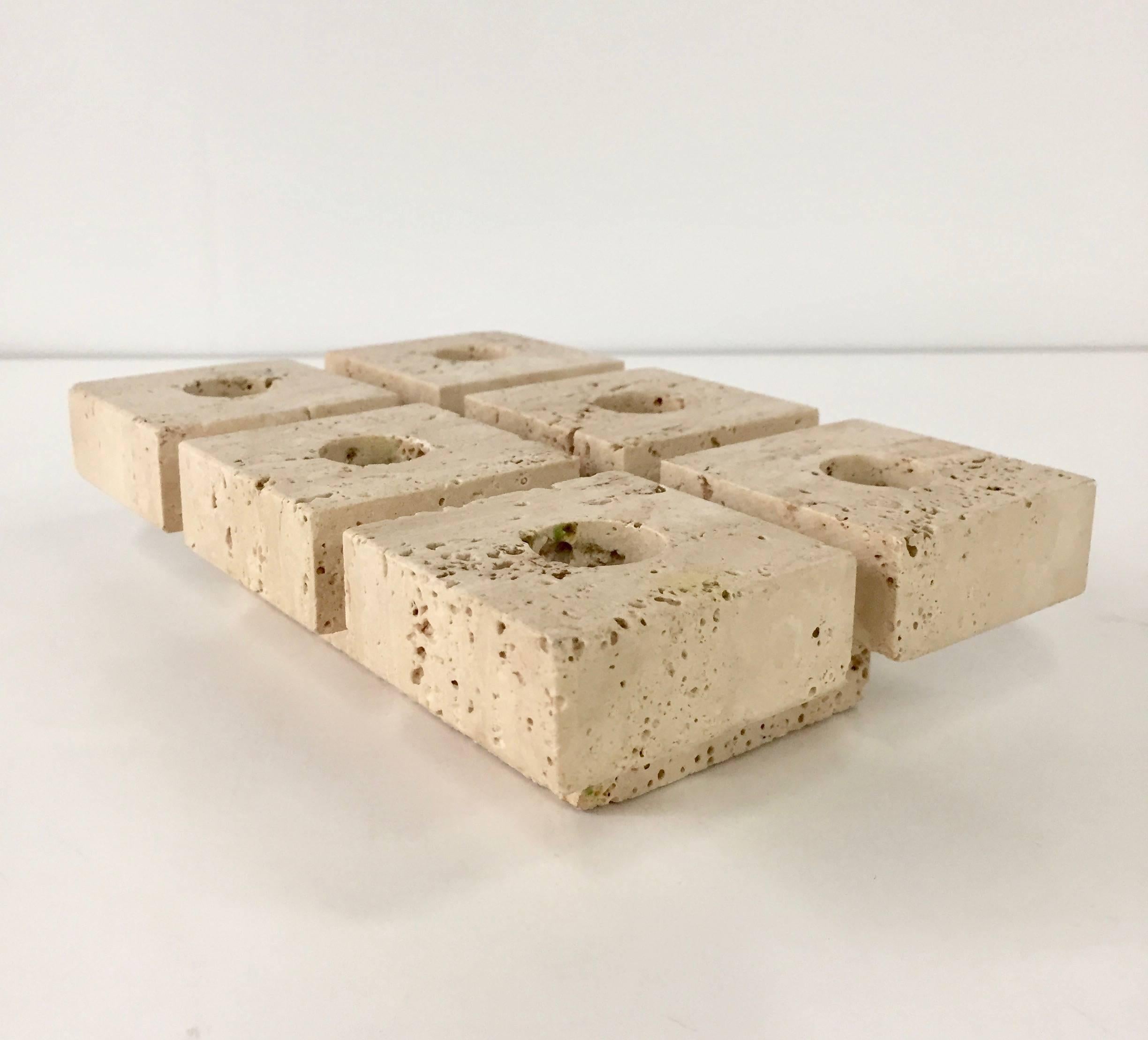Modernist travertine candleholder in the manner of Mangiarotti. Six squares hold candles.
 