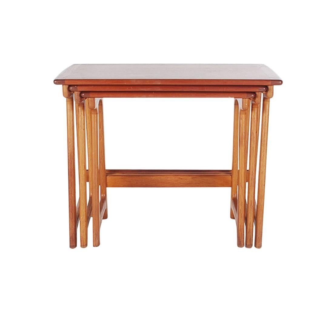 A lovely set of three nesting tables designed by Kai Kristiansen. Well made and a step above the rest. These tables feature solid teak construction and lock together tightly.