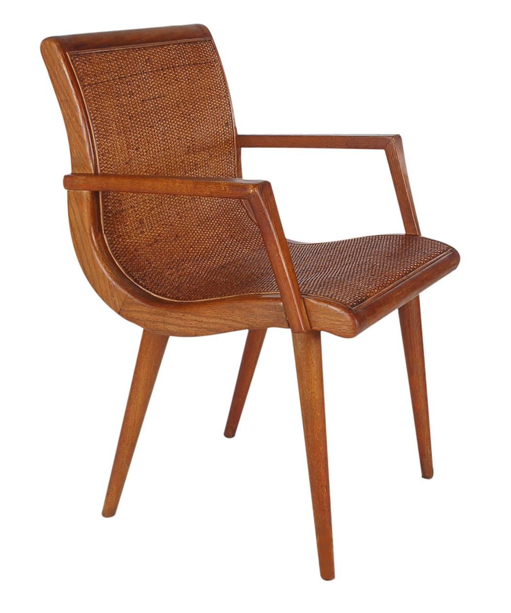 A very handsome pair of matching side chairs from the 1950s. They feature solid oak framing with full cane seat and back rests.