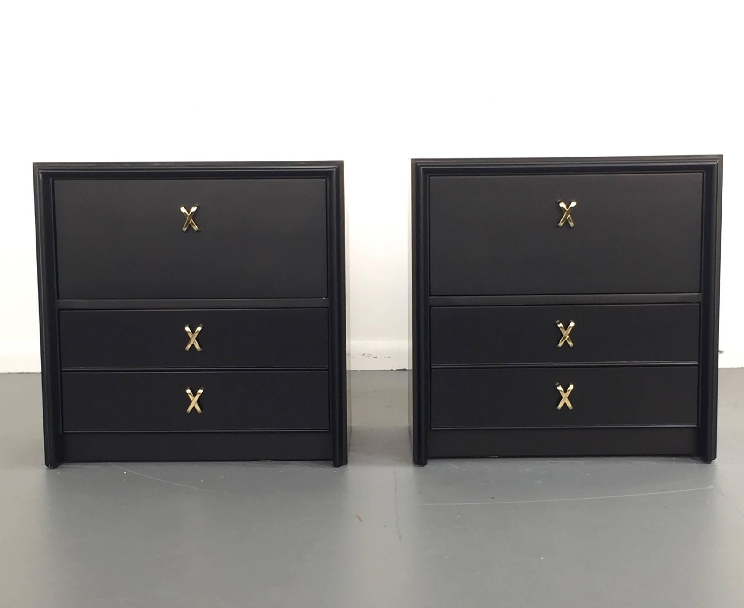 Pair of nightstands with "X" pulls designed by Paul Frankl in the 1950s for Johnson Furniture Company. Each nightstand has 2 drawers and a dropdown drawer accented by Frankl's signature "X" pulls. Newly refinished. 