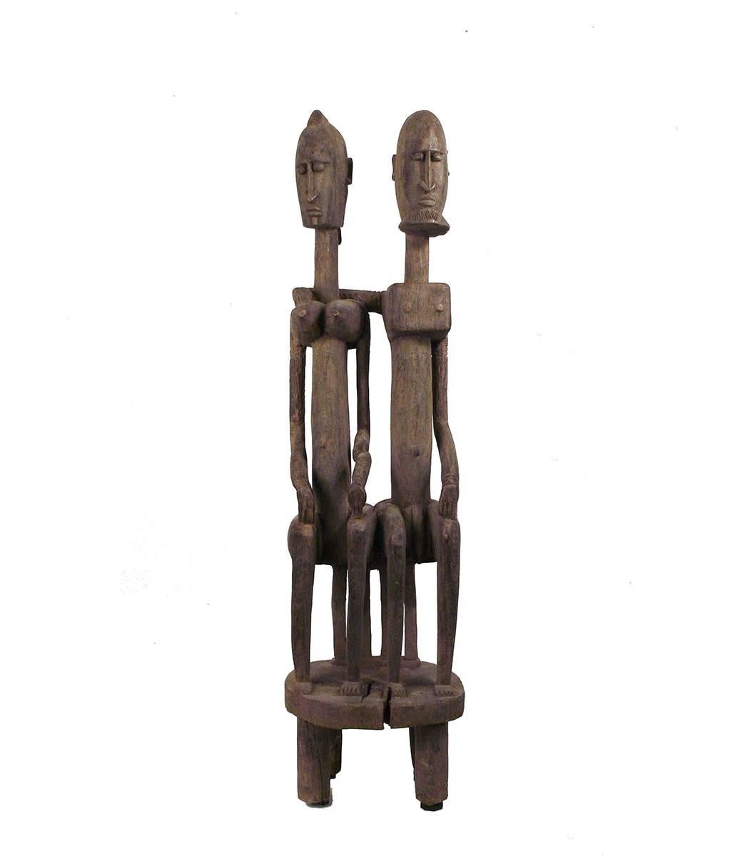 This wonderful old wooden figure represents the role of each sex in the Dogon patriarchal society. It was probably placed on a shrine. Beautiful timeworn patina; old little break on the woman's left arm. The man gesture, putting his arm around the