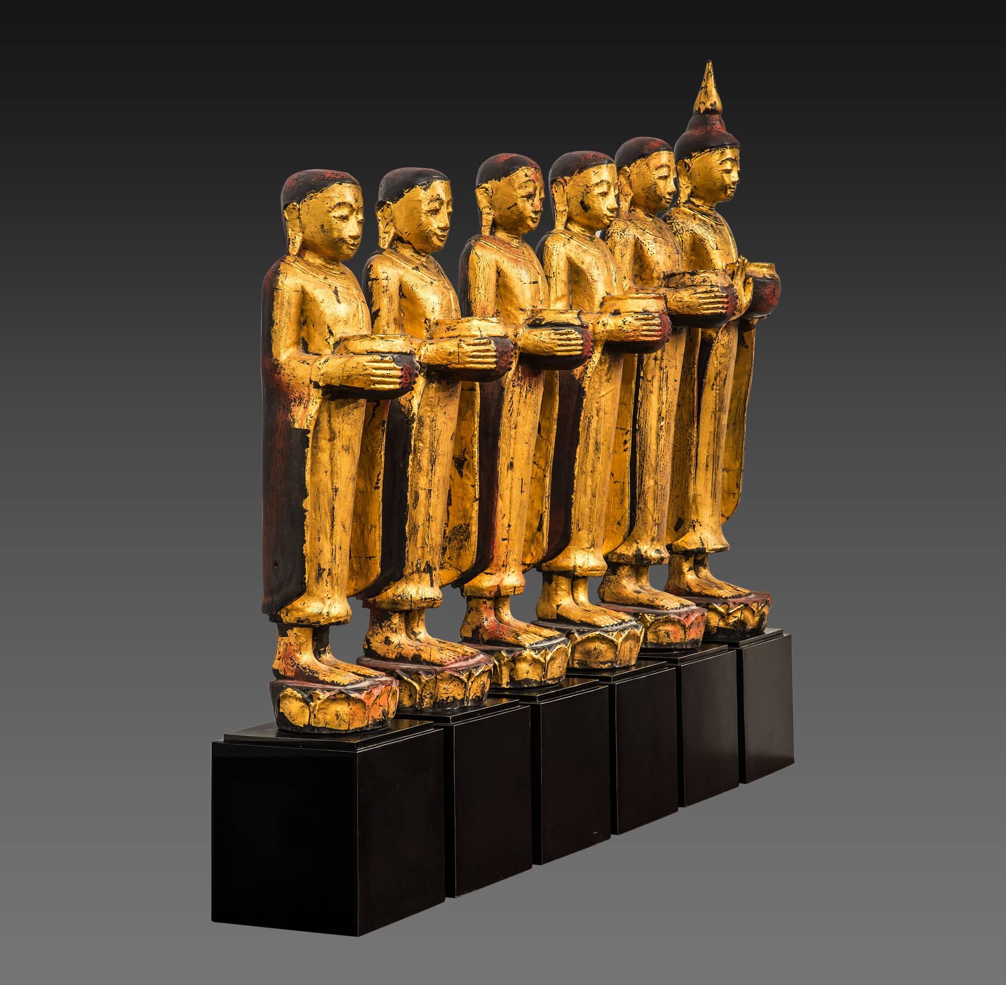 This set of wood sculptures depicting Buddha with his disciples. Buddha is different from disciples to the headgear for the height and the position of the right hand, raised in Abhayamudra, the gesture of fearlessness, of reassurance and safety,