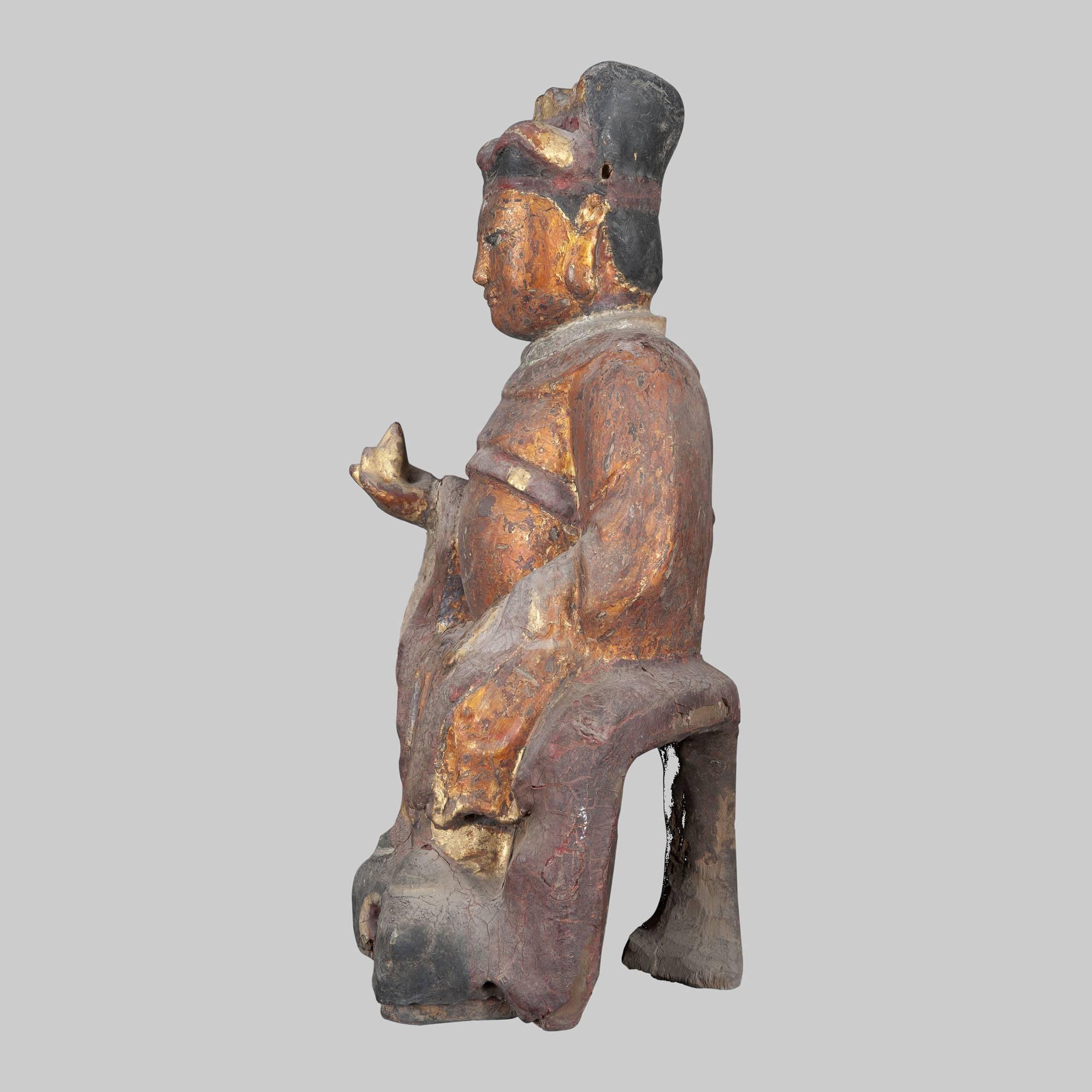 Ancient Chinese sculpture in polychrome wood. The time didn't affect the beauty of the work, and making the red color almost bronzed. The red on the face in China symbolizes the sacredness of the person, so the sculpture depicts one of the many