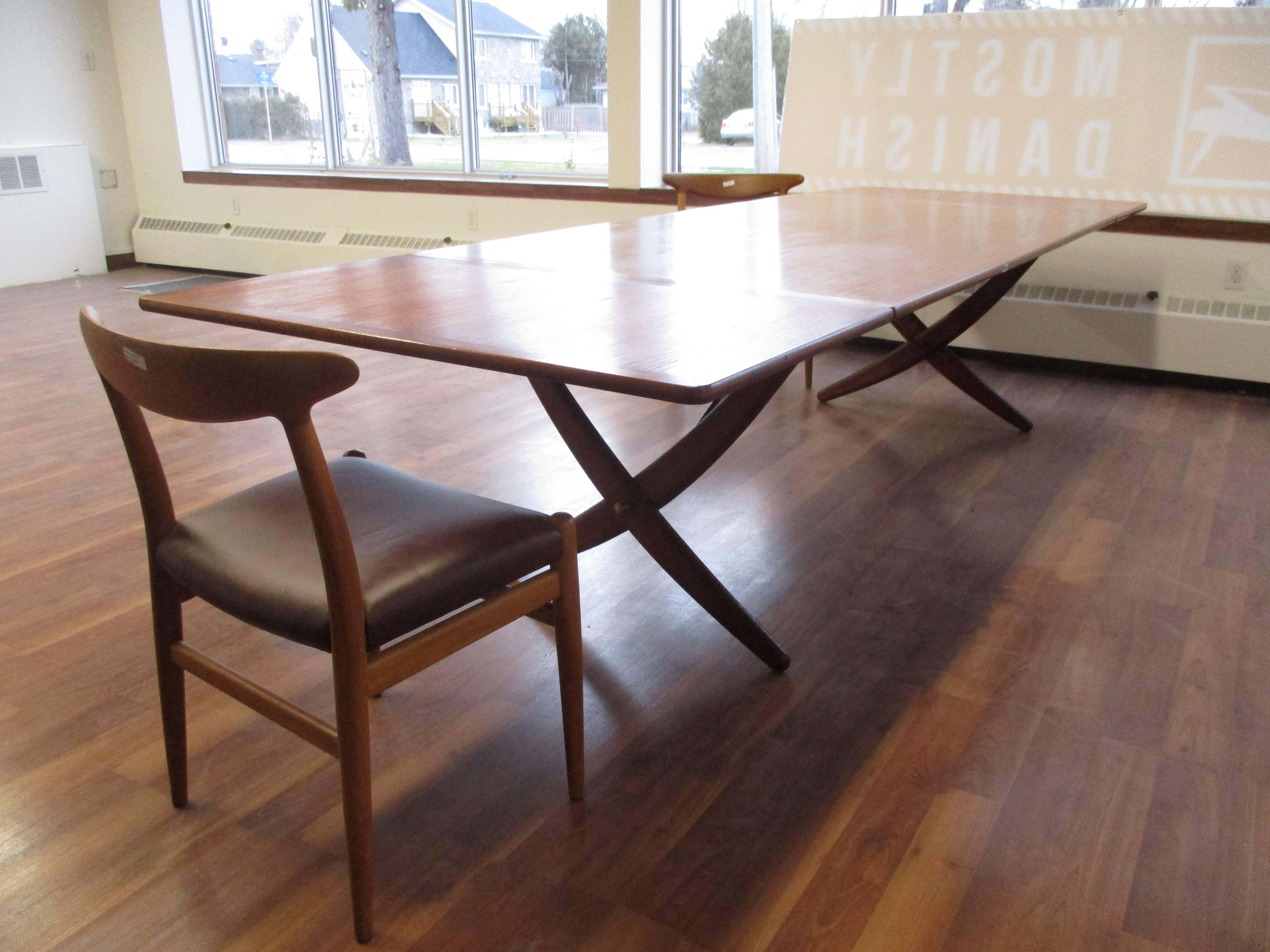 Hard to find Hans Wegner AT-314 dining table in teak with brass struts. Featuring extensions at both ends and sabre form legs, this table manufactured by Andreas Tuck in the 1960s is in excellent condition. Smaller AT-304 available as well.