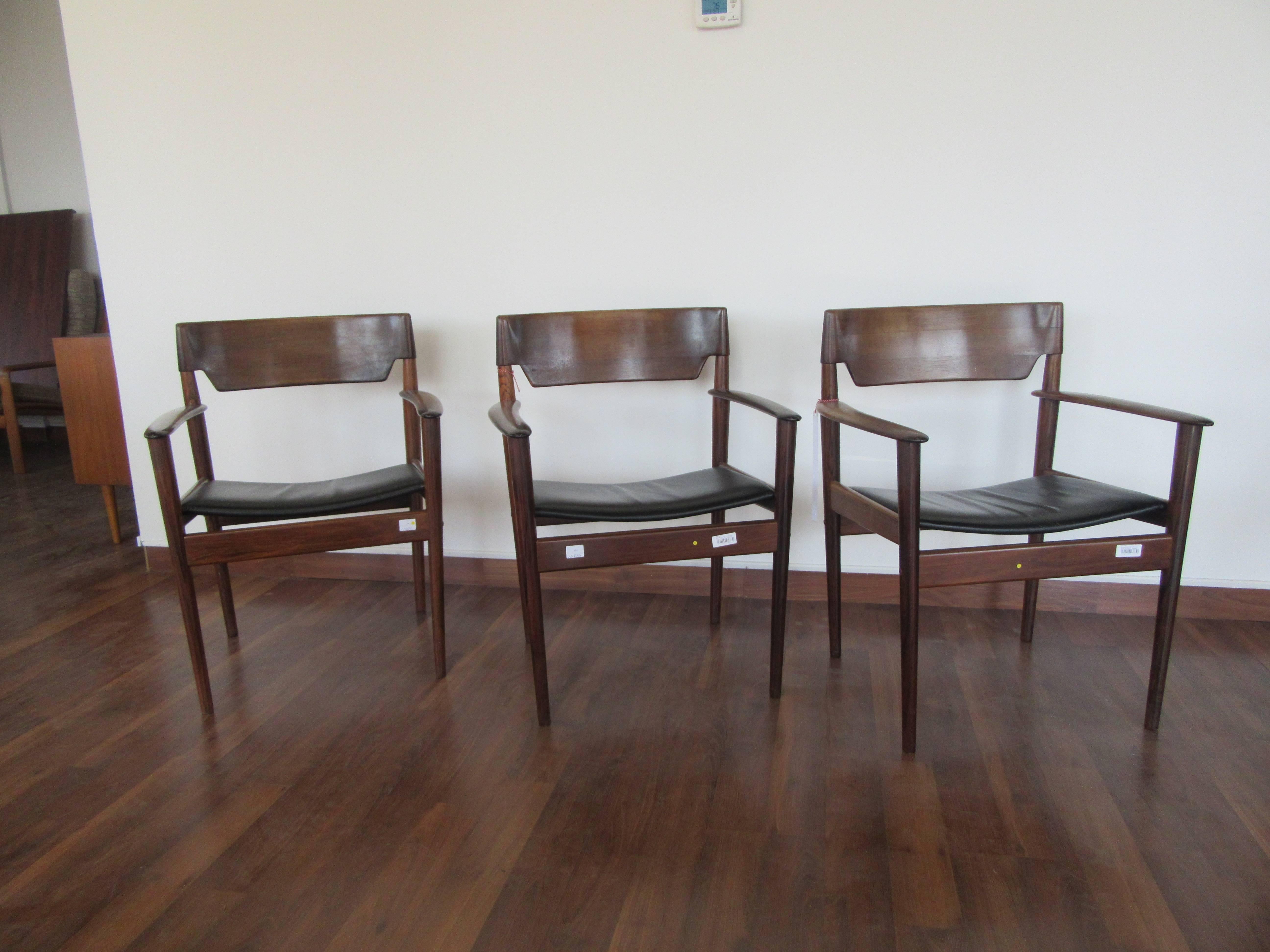 Rosewood armchairs by Grete Jalk with leather upholstery.