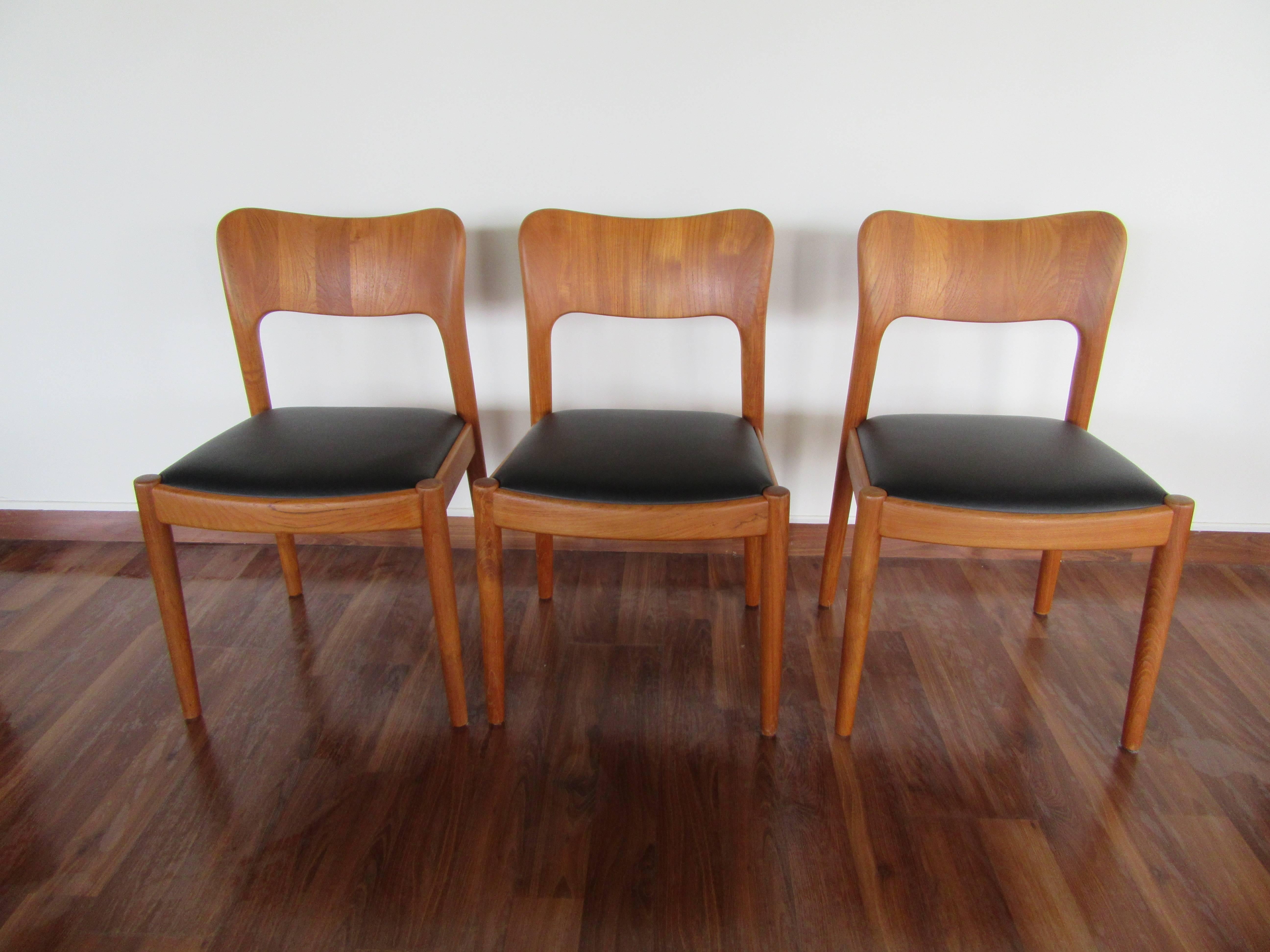 Beautiful chunky teak chairs upholstered in leather, manufactured by Koefoed Hornslet. Set of three.