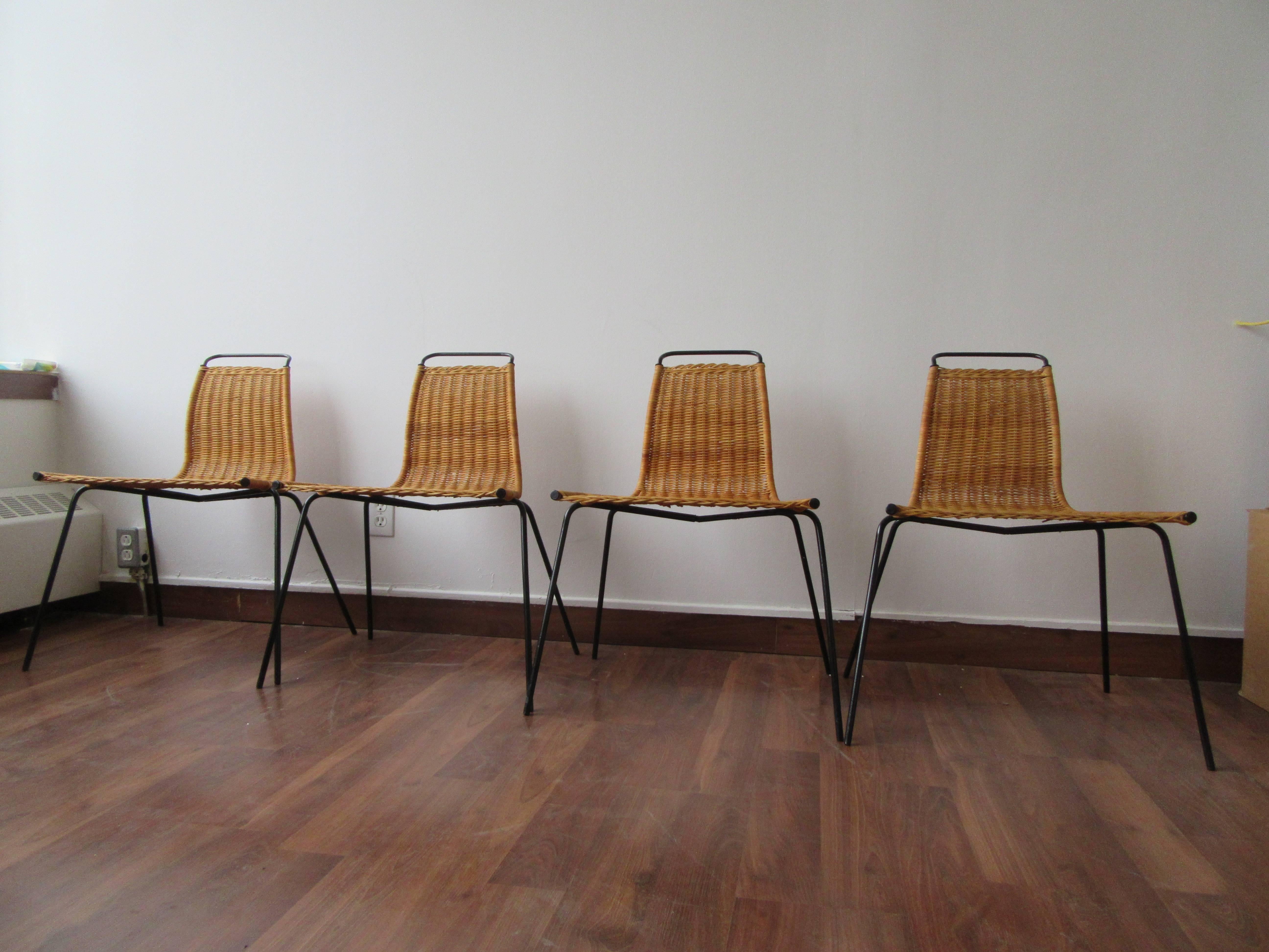 A set of four PK1 chairs by Poul Kjærholm. Featuring a steel frame and wicker upholstery. Eye-catching design from the 1950s.