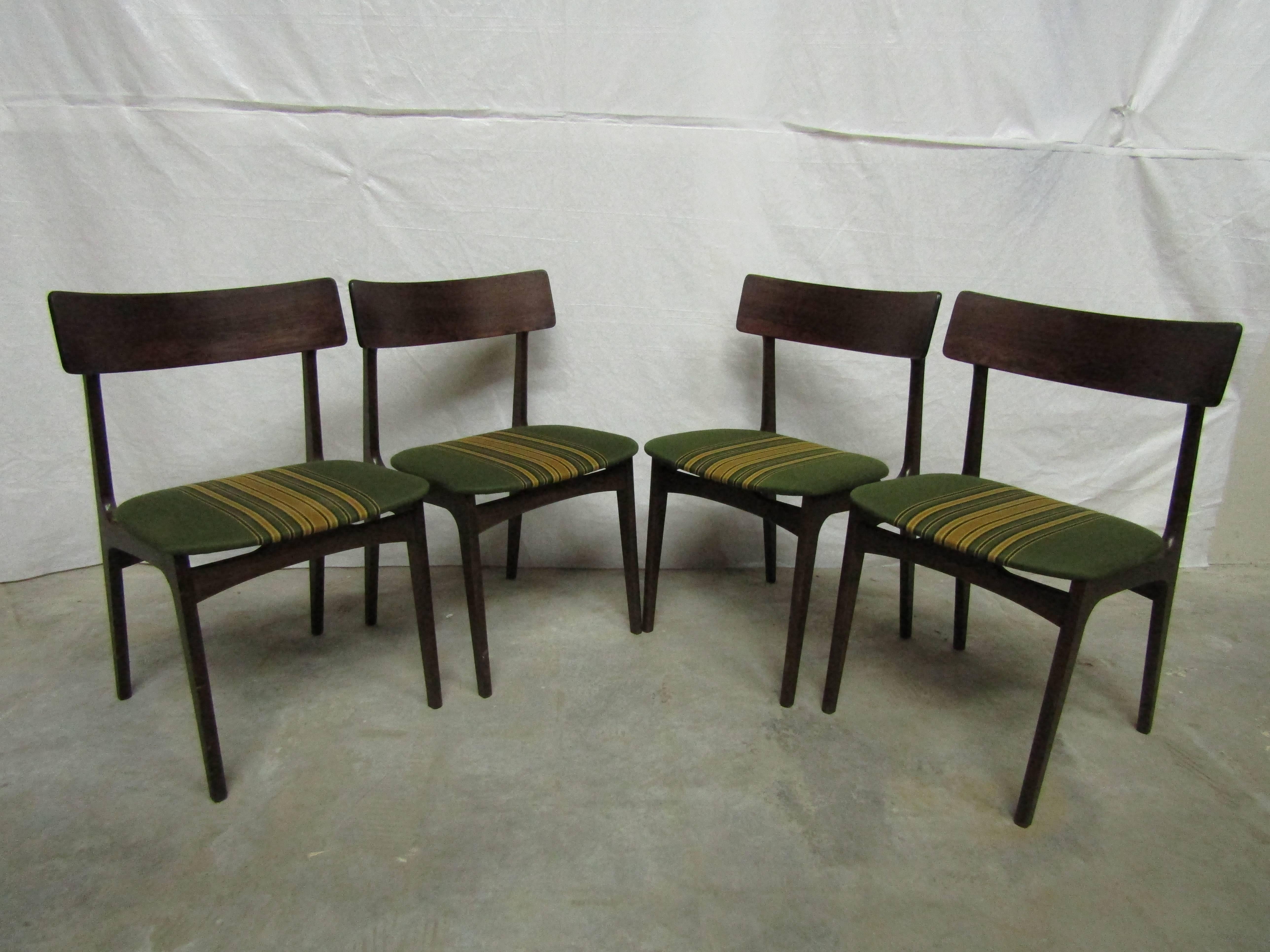 Set of four solid rosewood dining chairs with original upholstery made in Denmark.