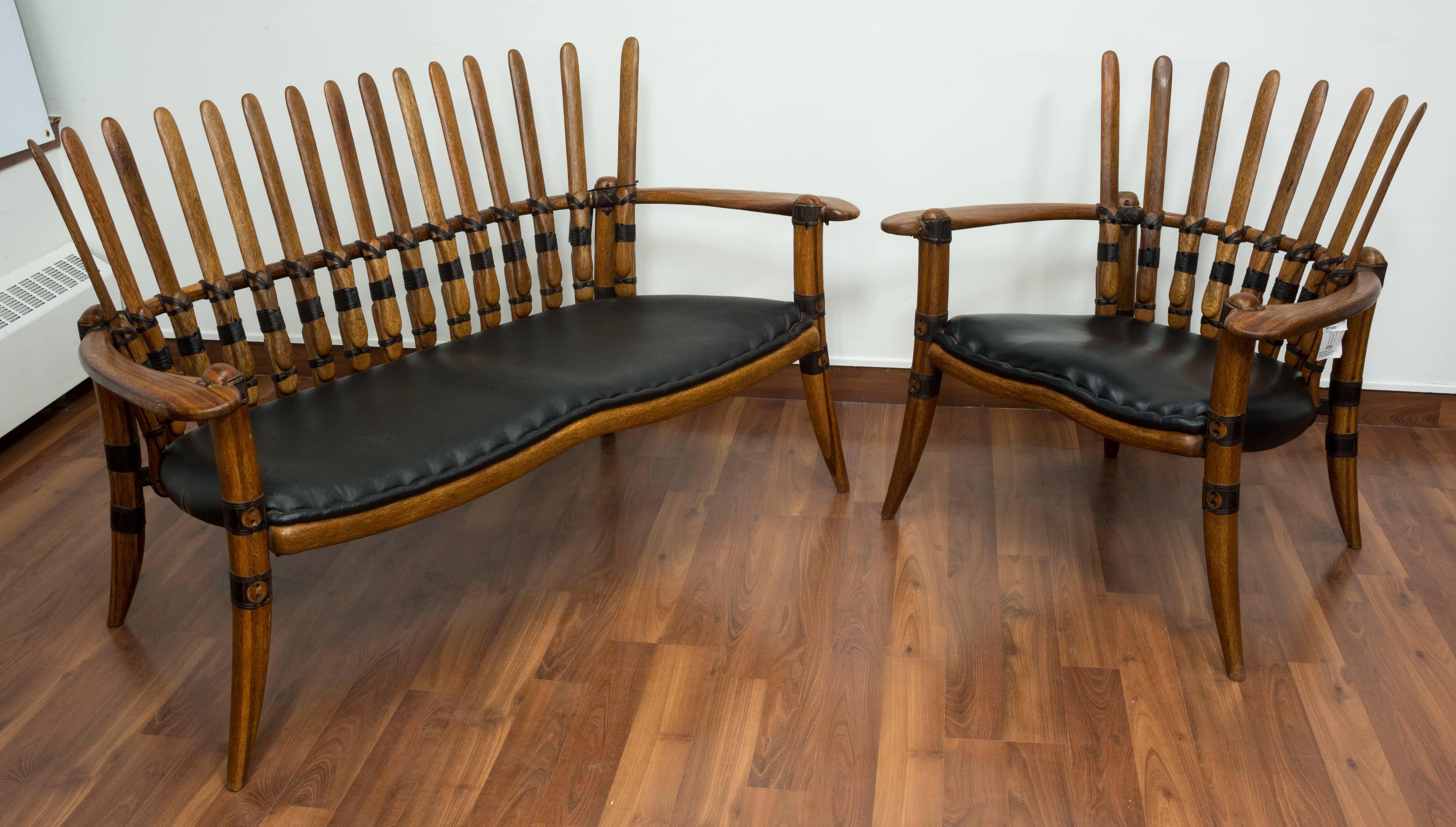 Polished palmwood frames. Joints made of leather bindings previously used for as handles. Latex seats upholstered in black leather, backs in lambskin.

Bruce Dowse for pacific green.

Measures: Easy chair H 88, W 85, D 77 cm.
 