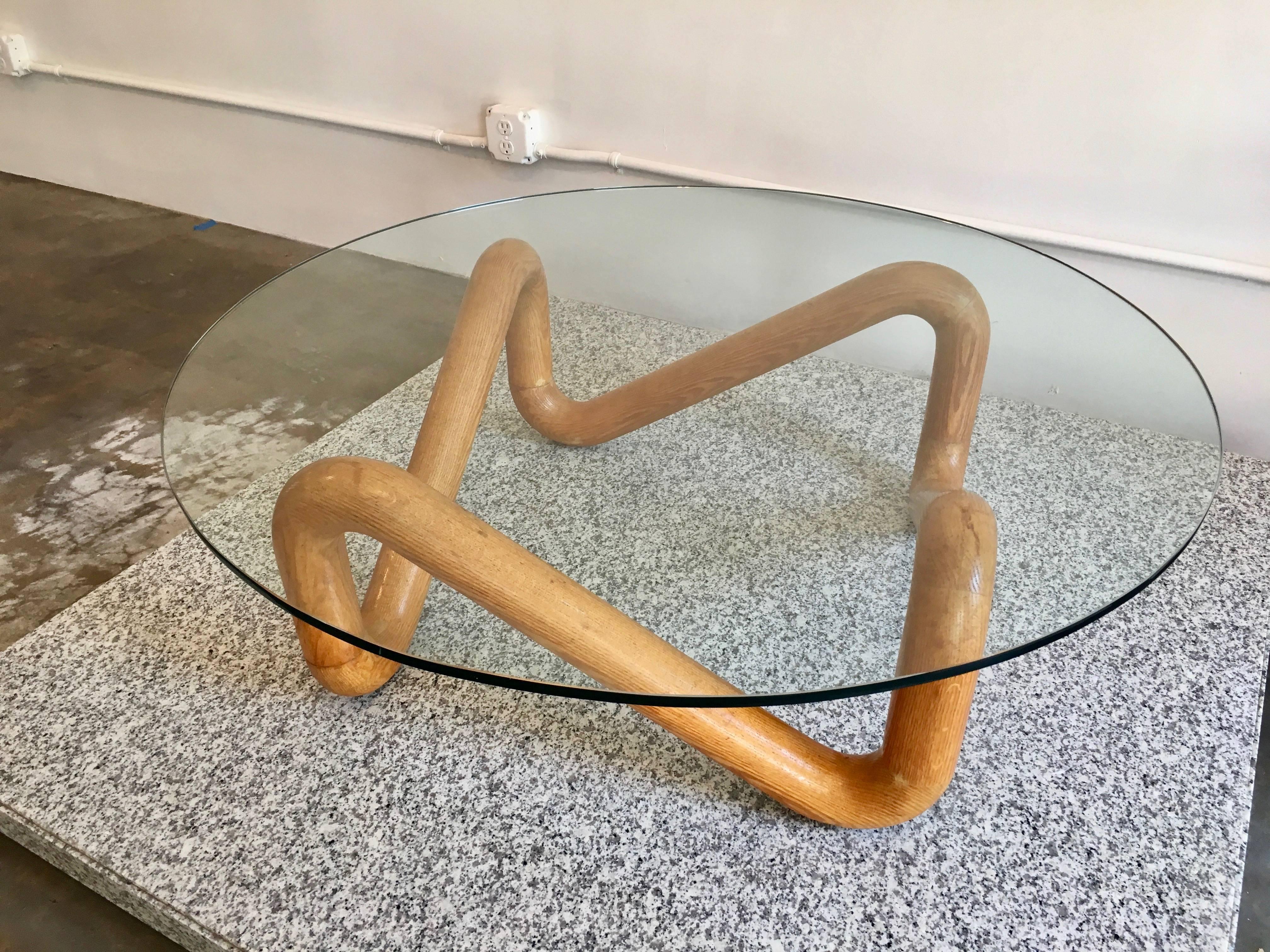Exceptional sculptural Harvey Prober coffee table with knotted form solid oak base and plate glass top. A remarkable early and scarce biomorphic design by Probber and documented in the 1952 