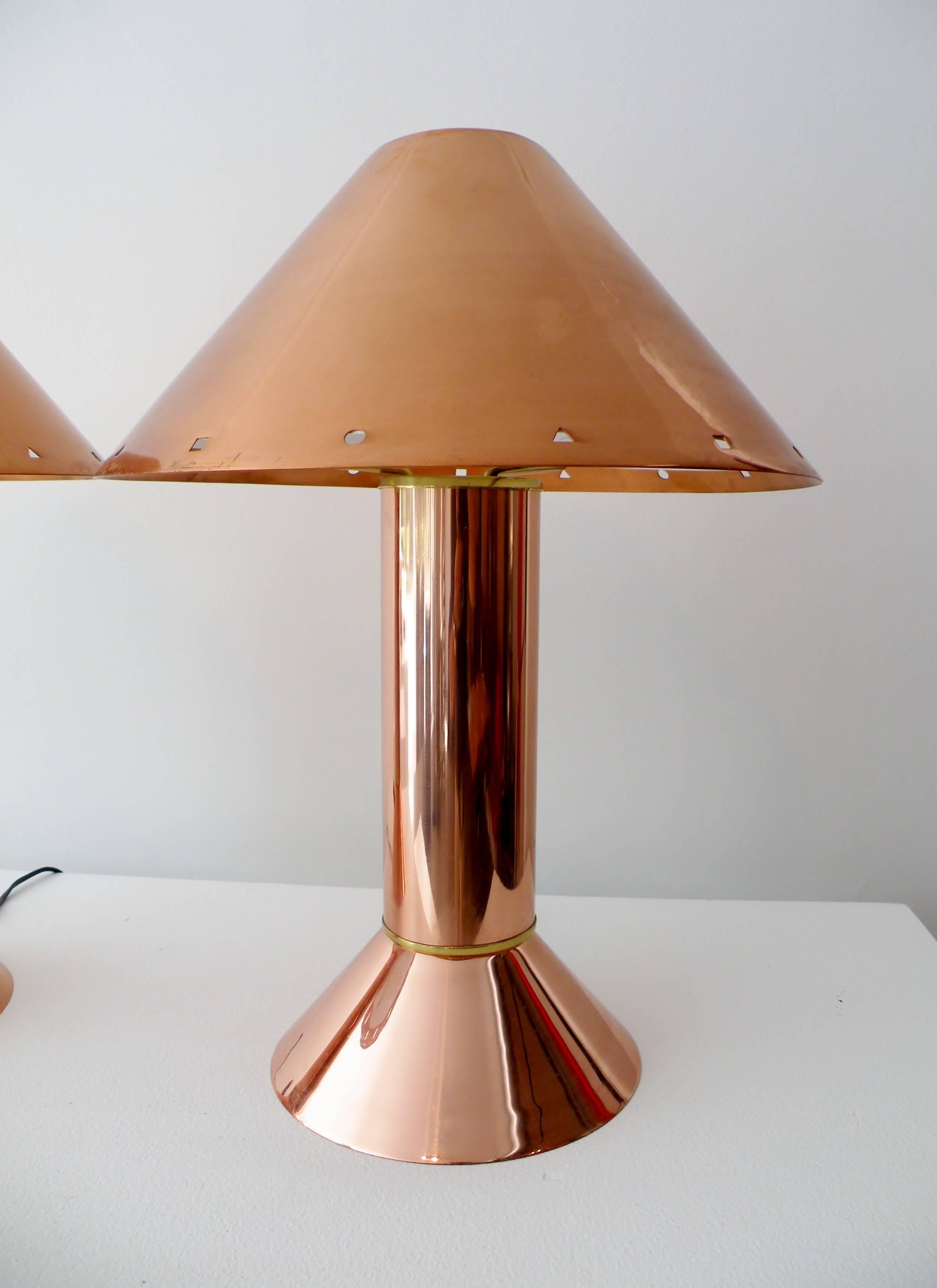 Iconic pair of 1980s Postmodernist Ron Rezek of California table or desk lamps. Classic form and motif of the era in timeless polished copper. Overall height 18