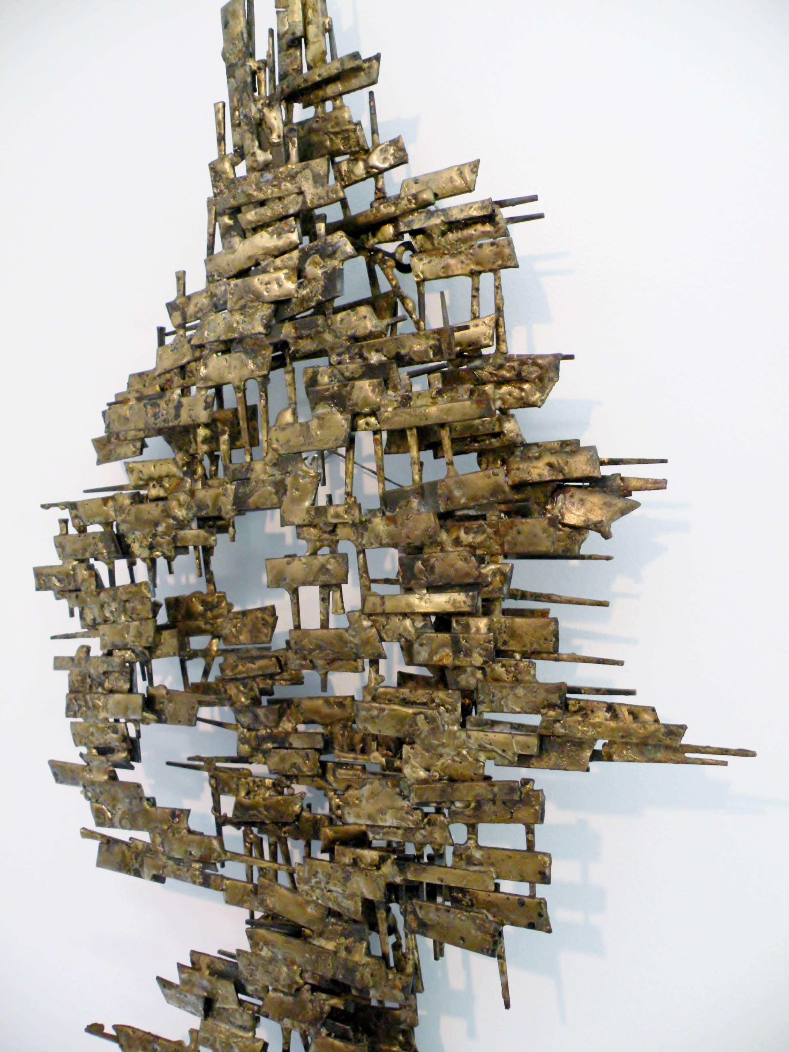 Abstract 1960s era Brutalist welded metal and nail with gilt highlights wall sculpture. 46