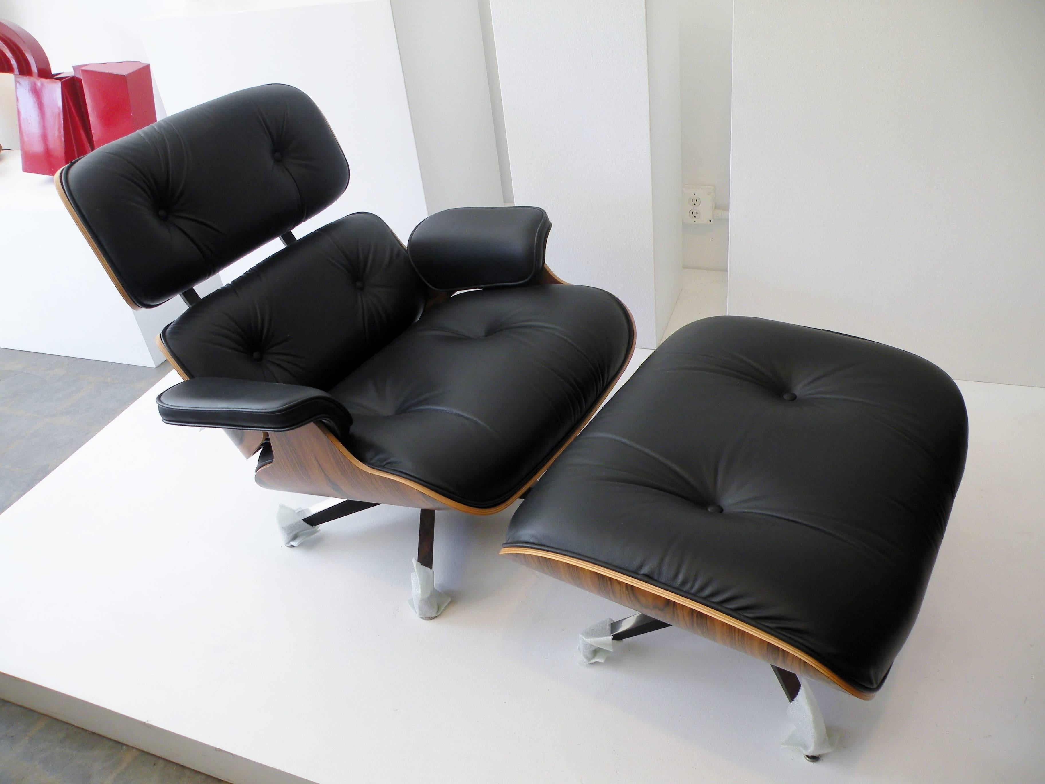 Iconic Charles and Ray Eames designed model 670 & 671 lounge chair and ottoman. Contemporary Herman Miller production, purchased and stored by previous owner. Retains original 