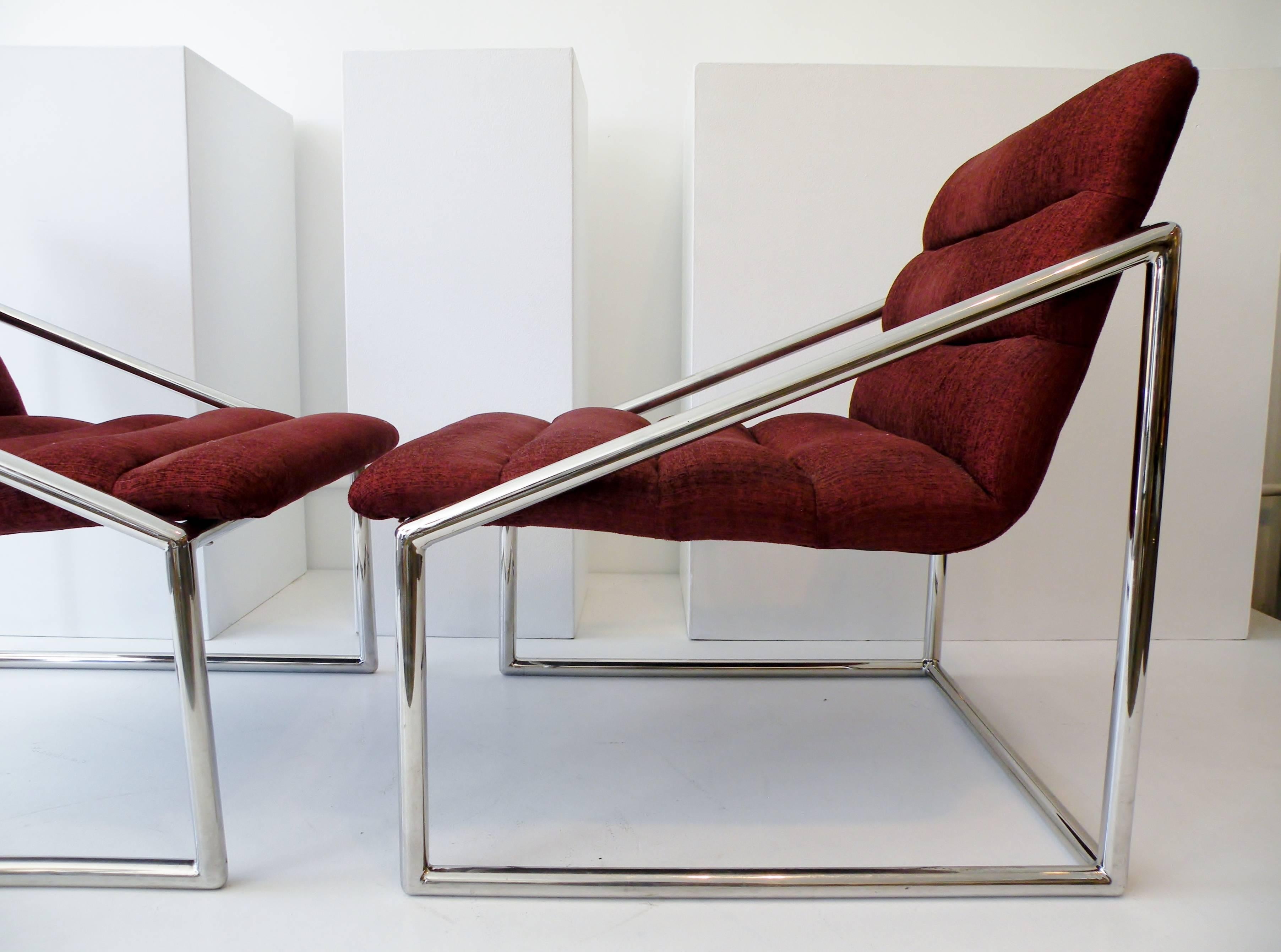 A sculptural pair of 1970s era cube form sling club lounge chairs. High quality tubular chromed steel construction from an unknown maker. Each with original silk upholstery and approx. 28.25