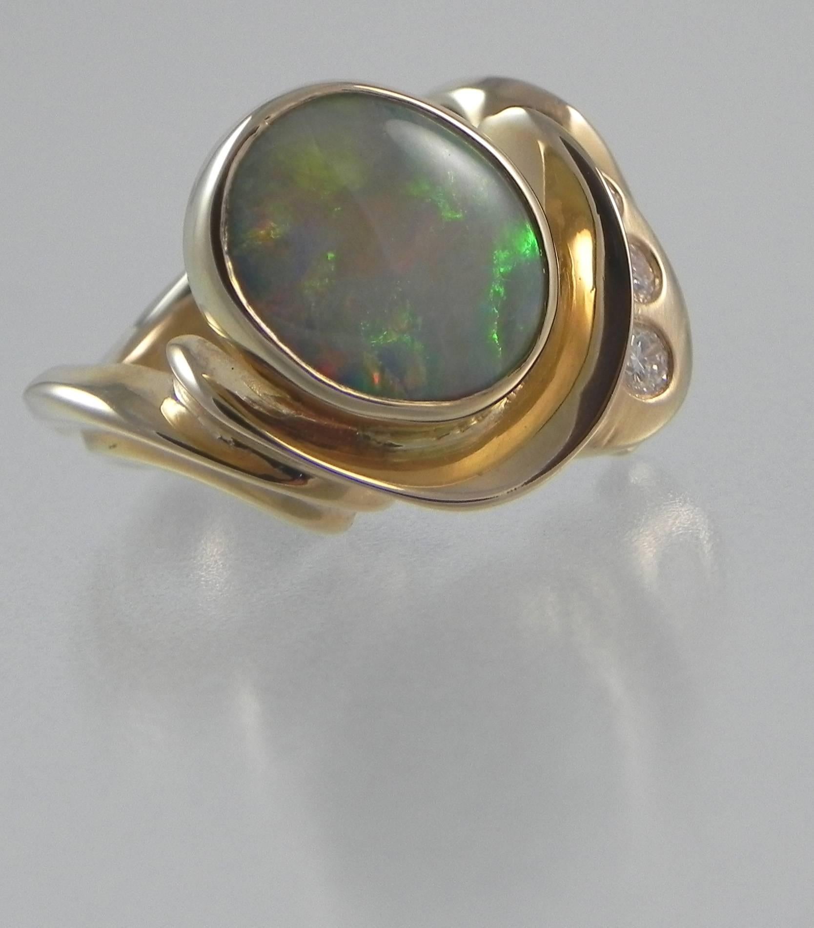 A 14Kt yellow gold one-of-a-kind ring by Colorado’s Premier Jewelry Studio and Master Craftsman – Steven M. Parks.  The ring is set with one oval cabochon fine Australian black opal that weighs 2.62 carets and set in a 14KT yellow gold handmade
